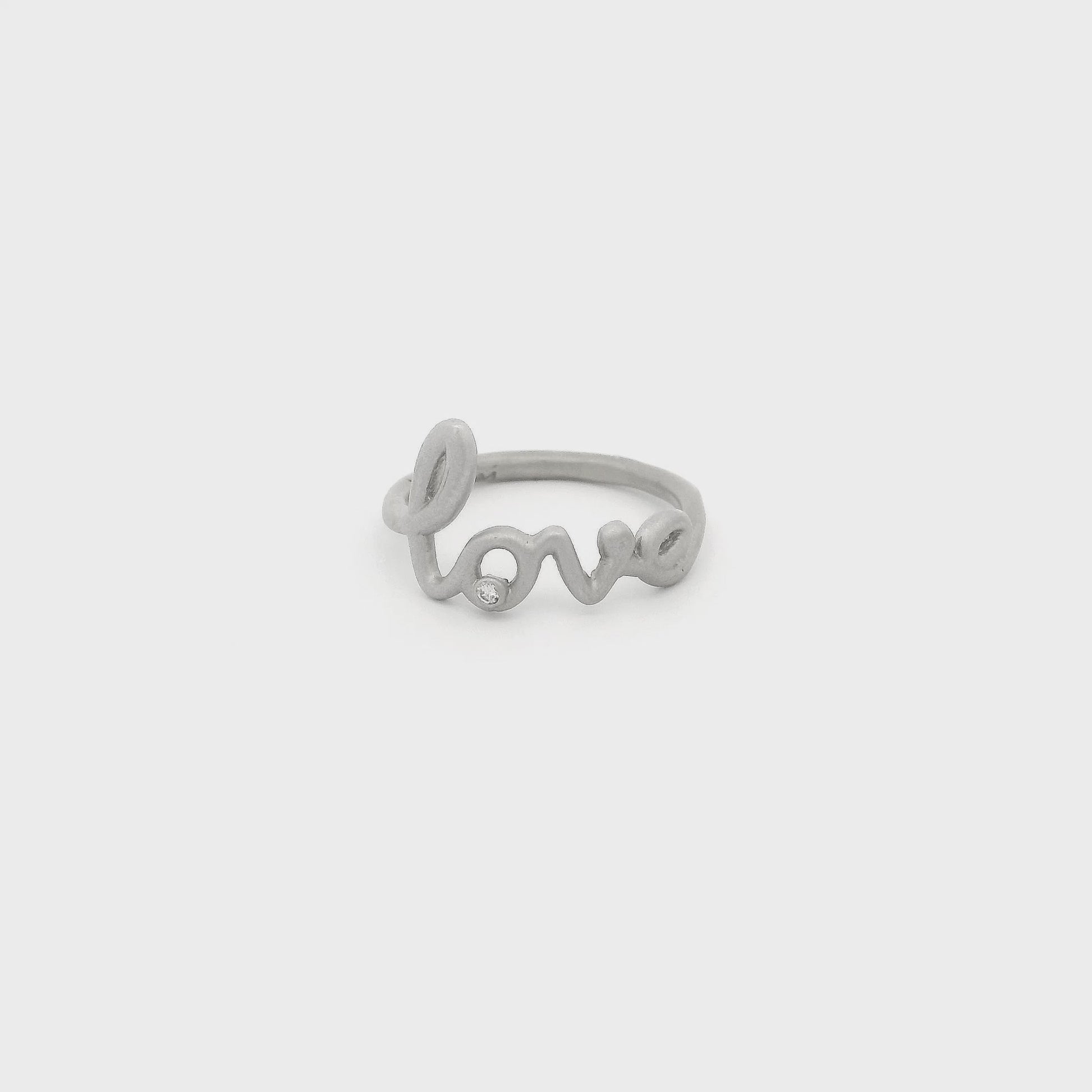 A White Gold Love Ring with a bezel set round cut natural Diamond in the bottom of the "O" at Forever Rox Fine Jewelry, Lake Tahoes Best Jewelry Store