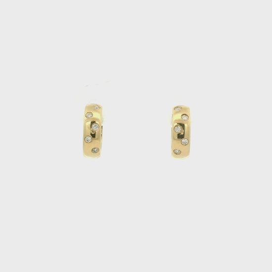 A Pair of Yellow Gold Hoop Earrings with flush set round cut natural Diamonds scattered in the gold at Forever Rox Fine Jewelry, Lake Tahoes Best Jewelry Store