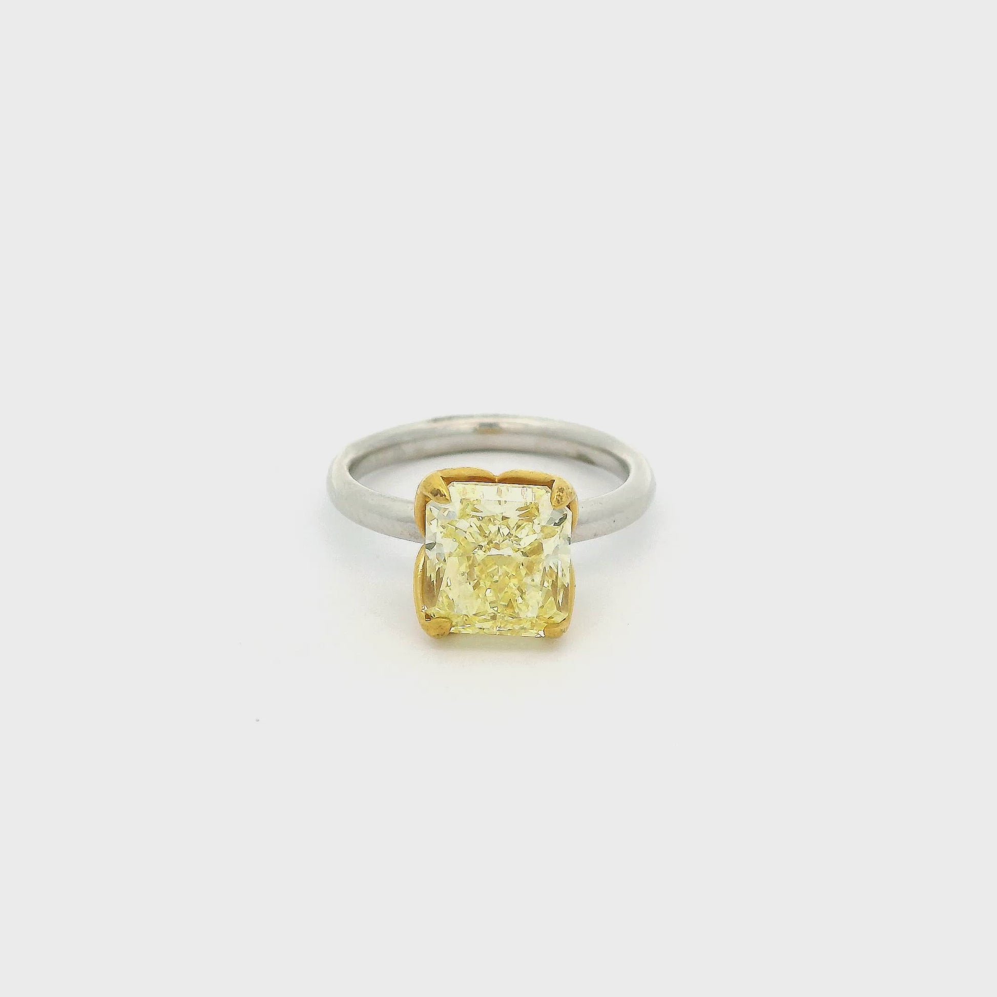 A White Gold Ring with a prong set square cushion cut natural Fancy Yellow Diamond in the center set in yellow gold at Forever Rox Fine Jewelry, Lake Tahoes Best Jewelry Store