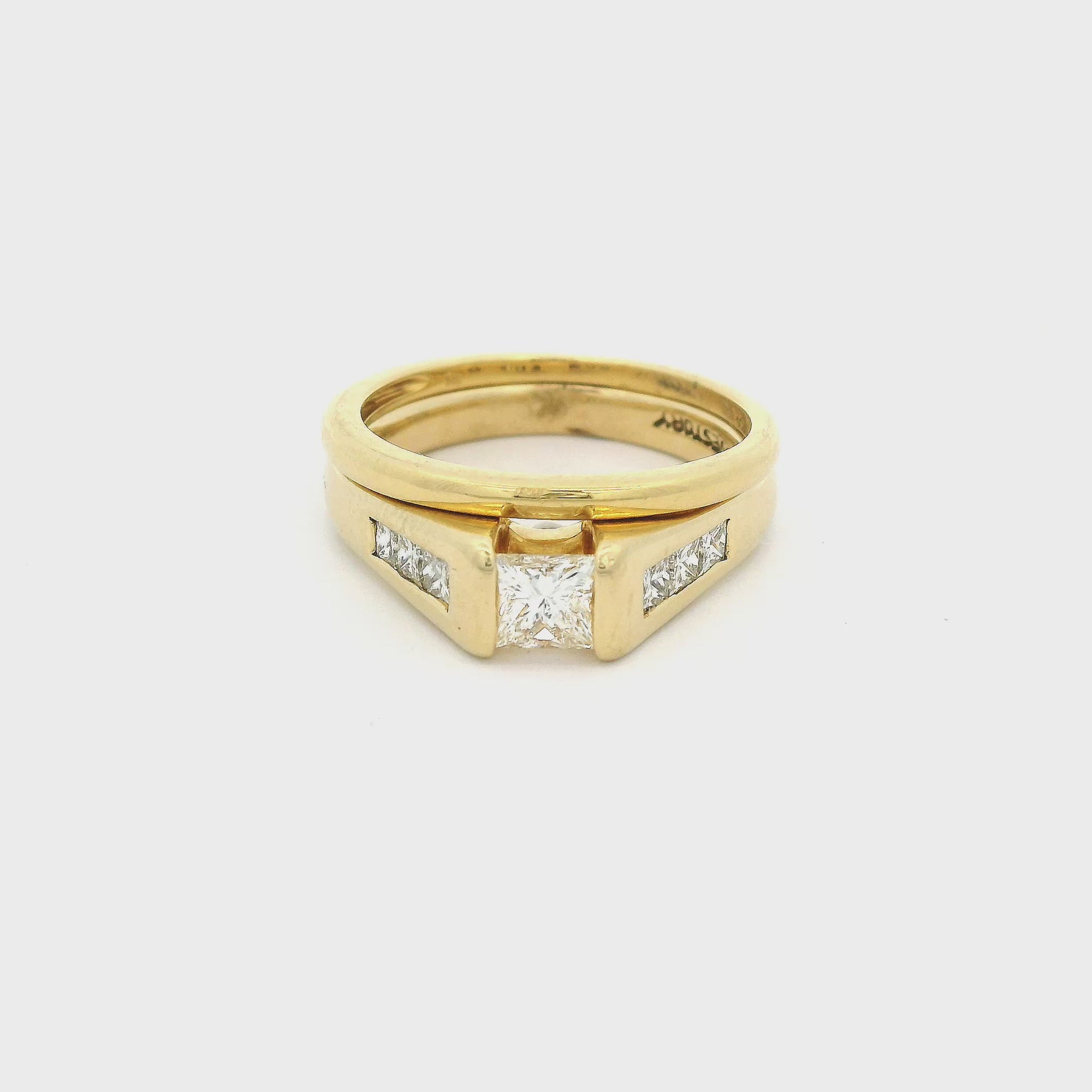 Gold ring with a central princess cut diamond and orincess cut diamonds channel set and a matching gold band at Forever Rox Fine Jewelry
