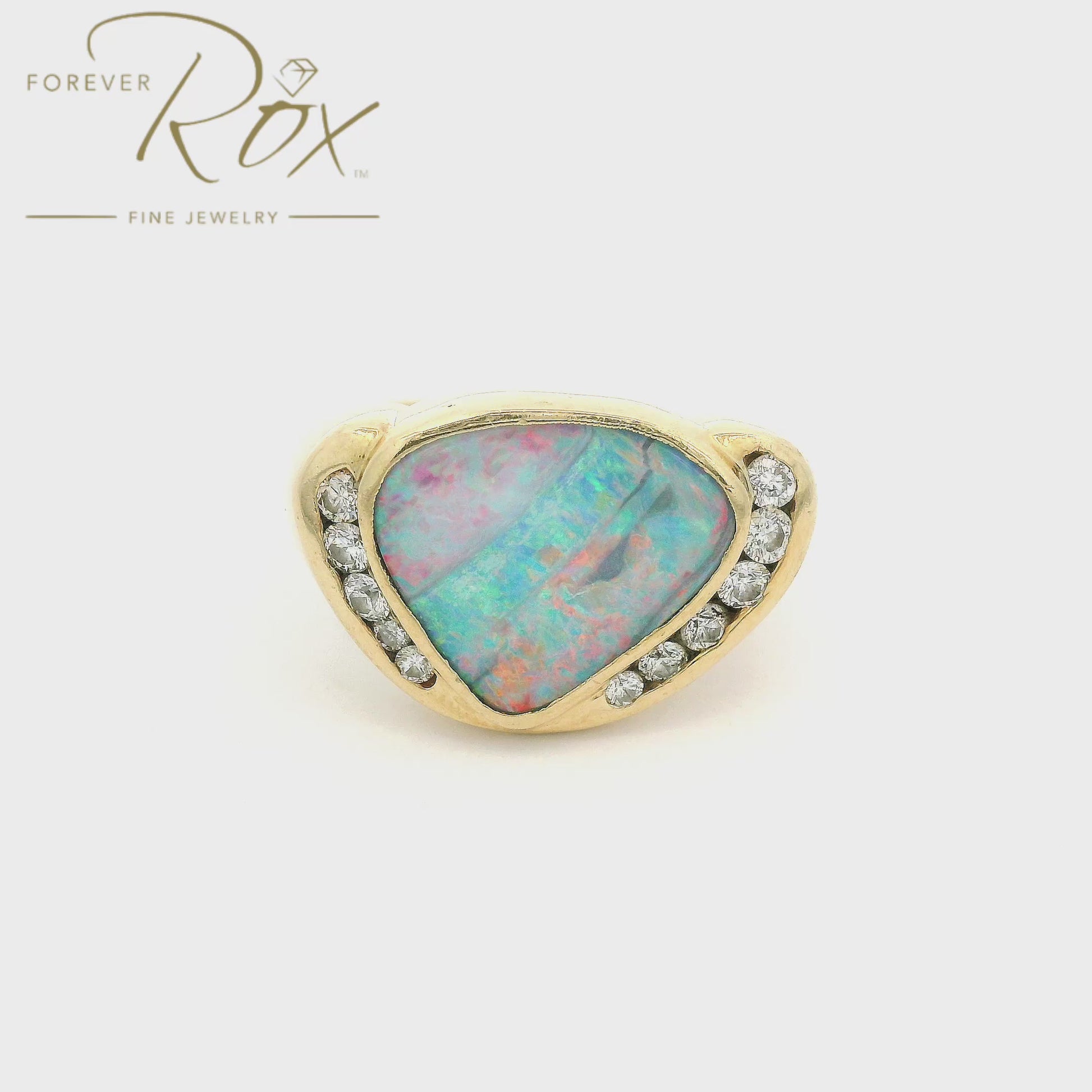 A Yellow Gold Ring with a bezel set natural Boulder Opal in the center with bezel set diamonds at Forever Rox Fine Jewelry, Lake Tahoes Best Jewelry Store