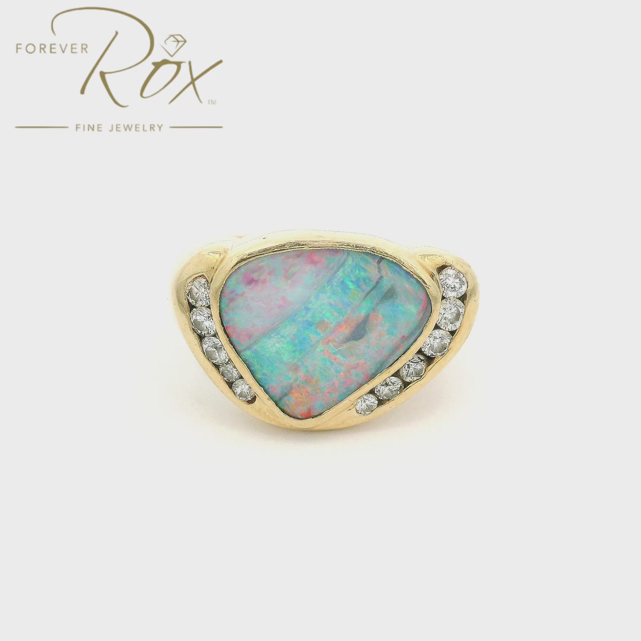A Yellow Gold Ring with a bezel set natural Boulder Opal in the center with bezel set diamonds at Forever Rox Fine Jewelry, Lake Tahoes Best Jewelry Store