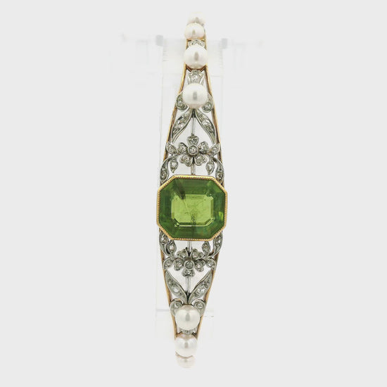 A Yellow Bracelet with a bezel set ascher cut natural Peridot in the center with diamonds and perals set in white gold floral designs at Forever Rox Fine Jewelry, Lake Tahoes Best Jewelry Store