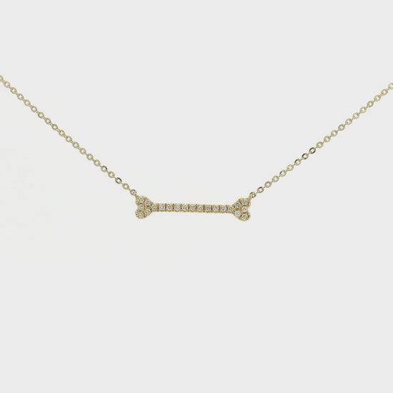 A Yellow Gold Dog Bone Pendant with diamonds at Forever Rox Fine Jewelry, Lake Tahoes Best Jewelry Store