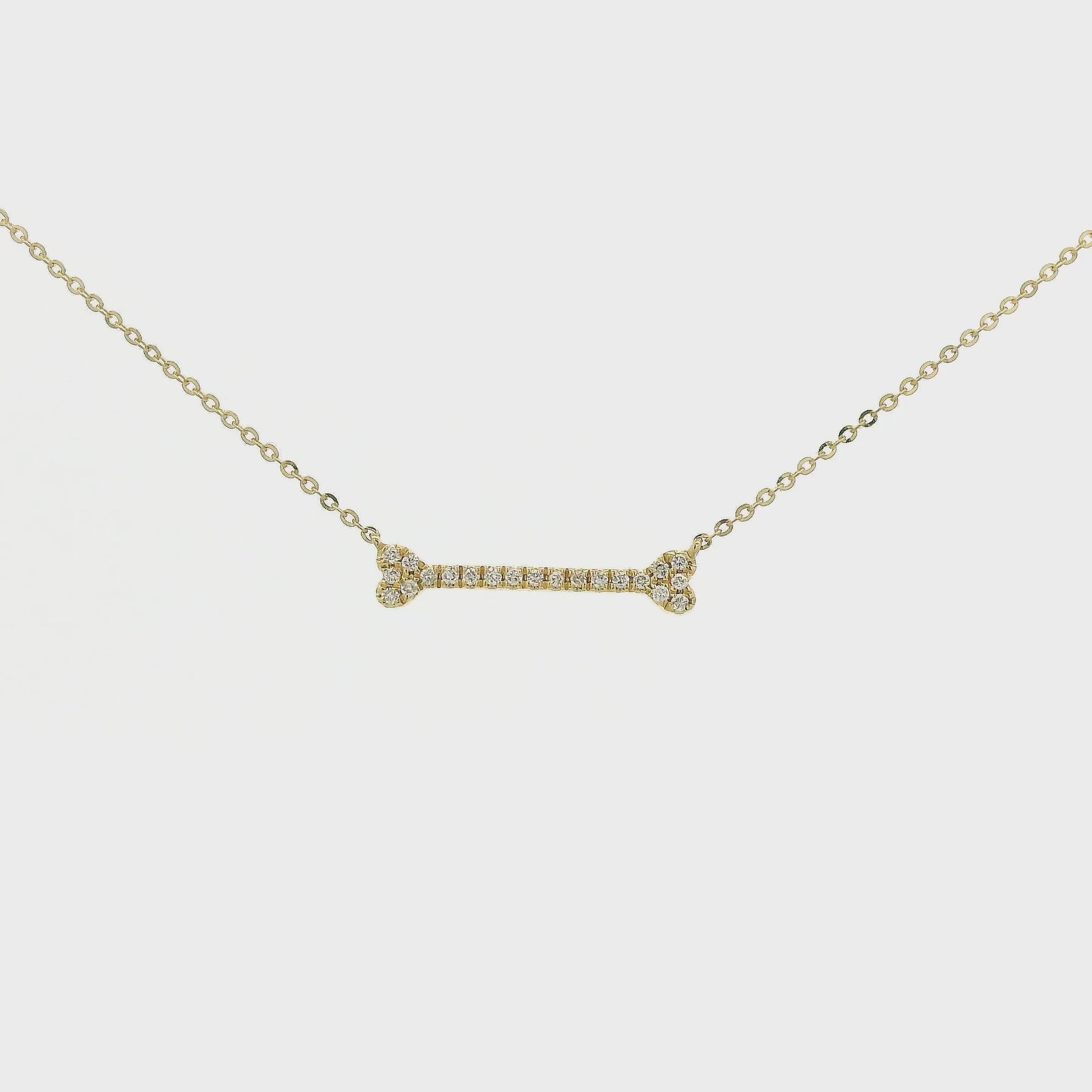 A Yellow Gold Dog Bone Pendant with diamonds at Forever Rox Fine Jewelry, Lake Tahoes Best Jewelry Store