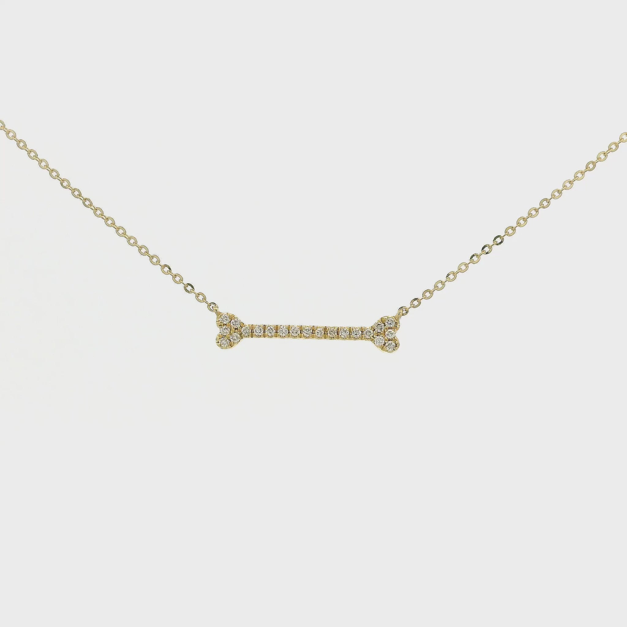 A Yellow Gold Dog Bone Pendant with diamonds at Forever Rox Fine Jewelry, Lake Tahoes Best Jewelry Store