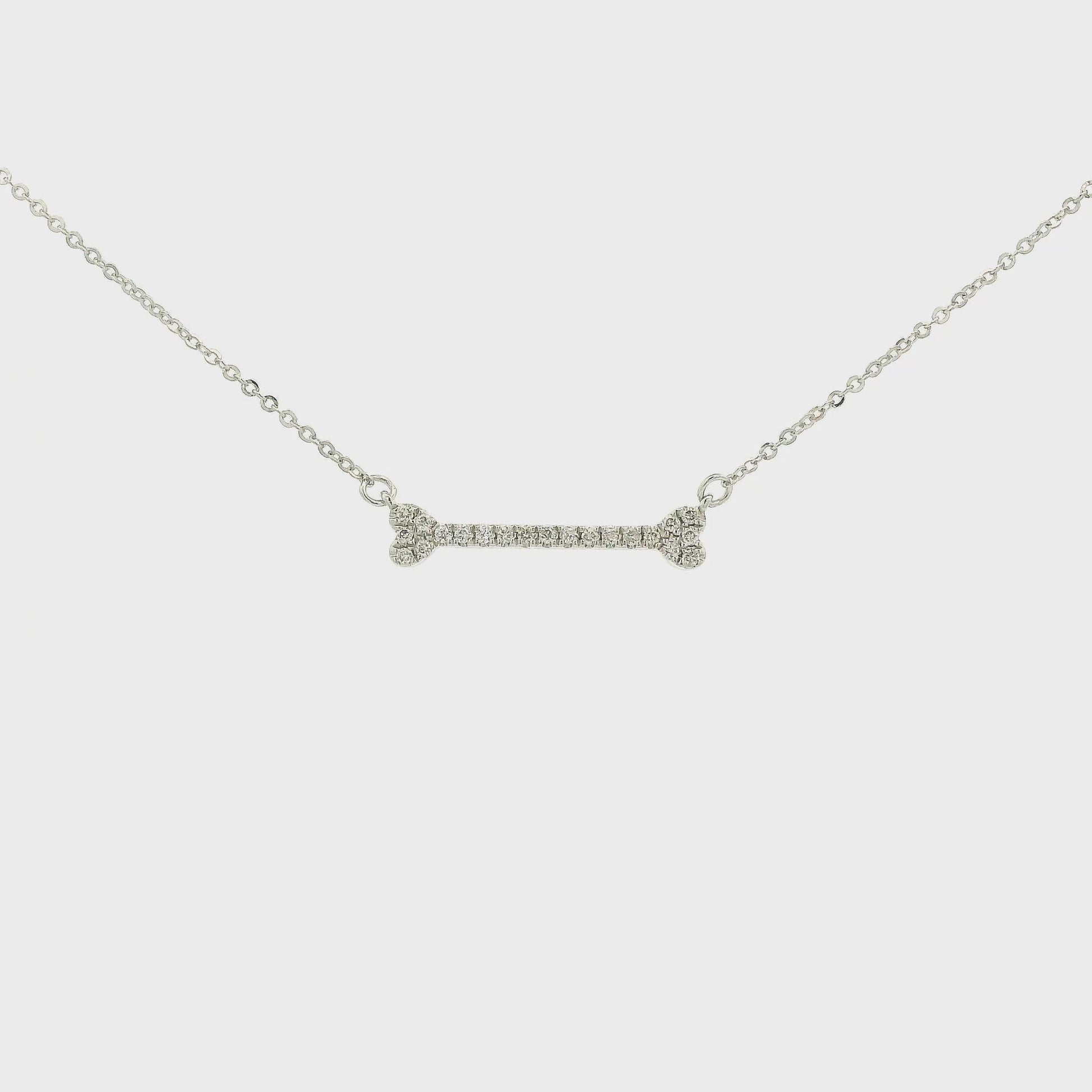 A White Gold Dog Bone Pendant with diamonds at Forever Rox Fine Jewelry, Lake Tahoes Best Jewelry Store