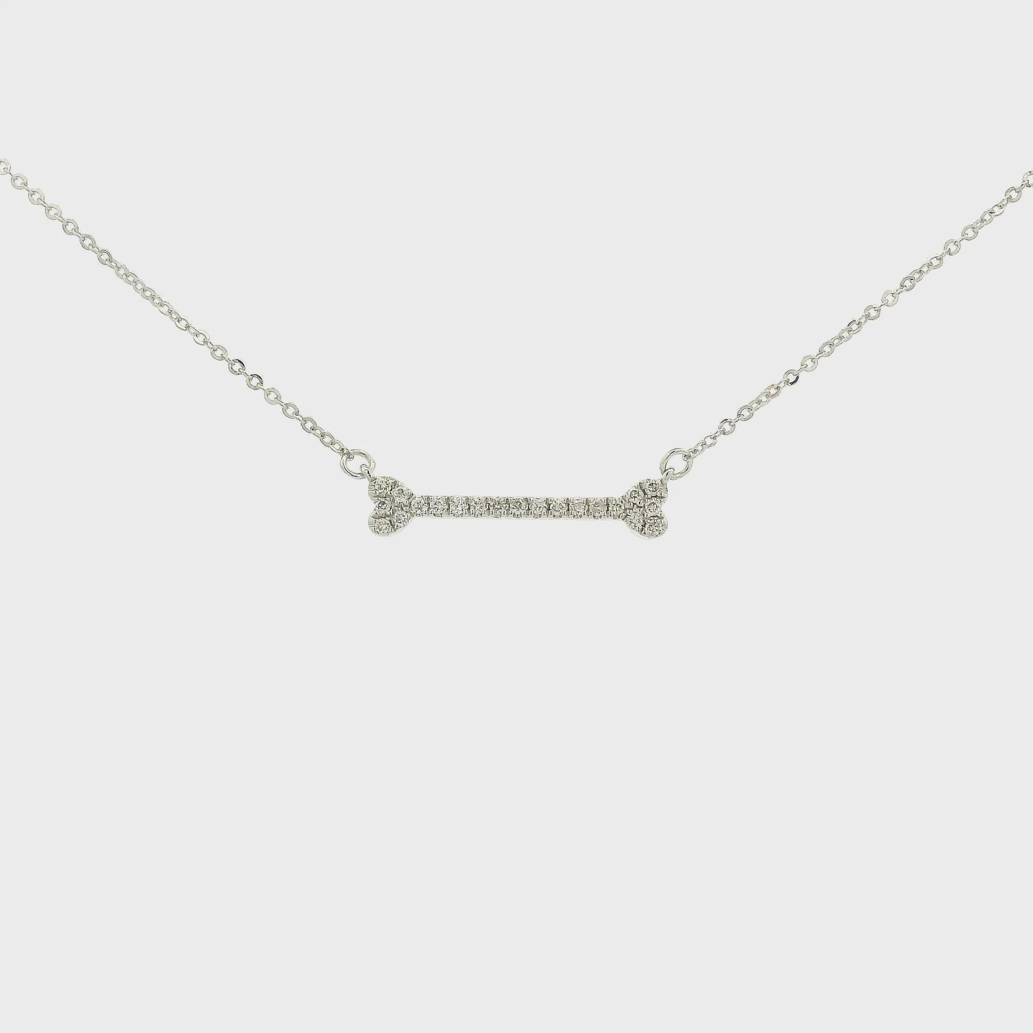 A White Gold Dog Bone Pendant with diamonds at Forever Rox Fine Jewelry, Lake Tahoes Best Jewelry Store