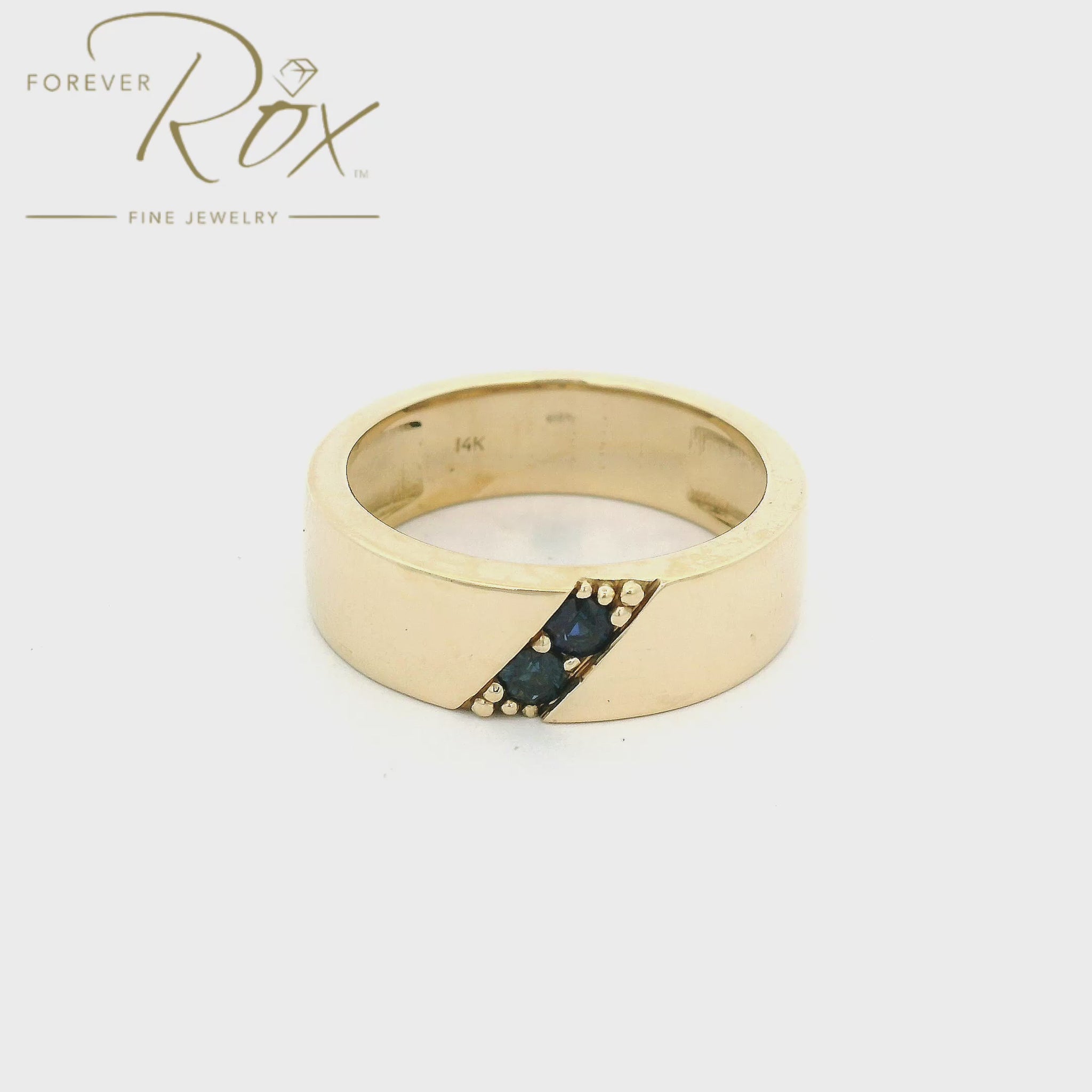 Yellow Gold Men's Band with two round cur blue sapphires set diagnolly in the center custom made at Forever Rox Fine Jewelry
