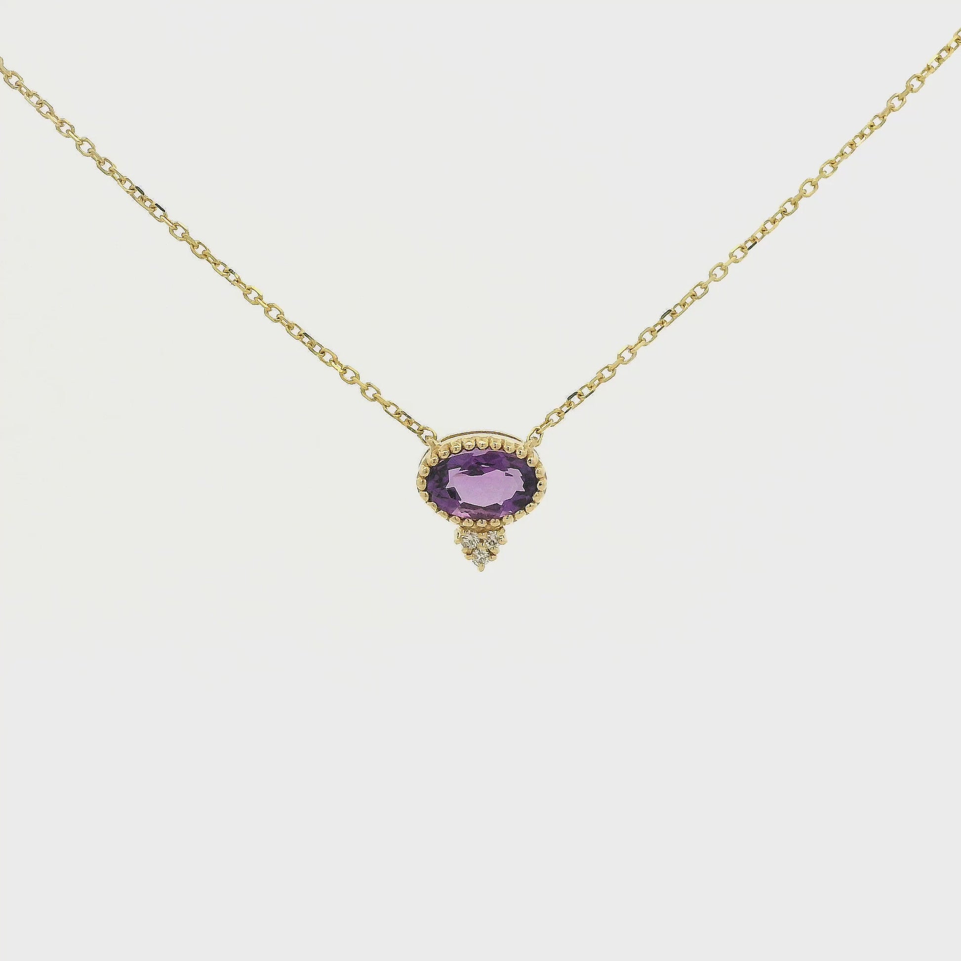 A Yellow Gold Pendant with a milgrain bezel set oval cut natural Amethyst in the center with 3 diamonds and a chain attached at Forever Rox Fine Jewelry, Lake Tahoes Best Jewelry Store