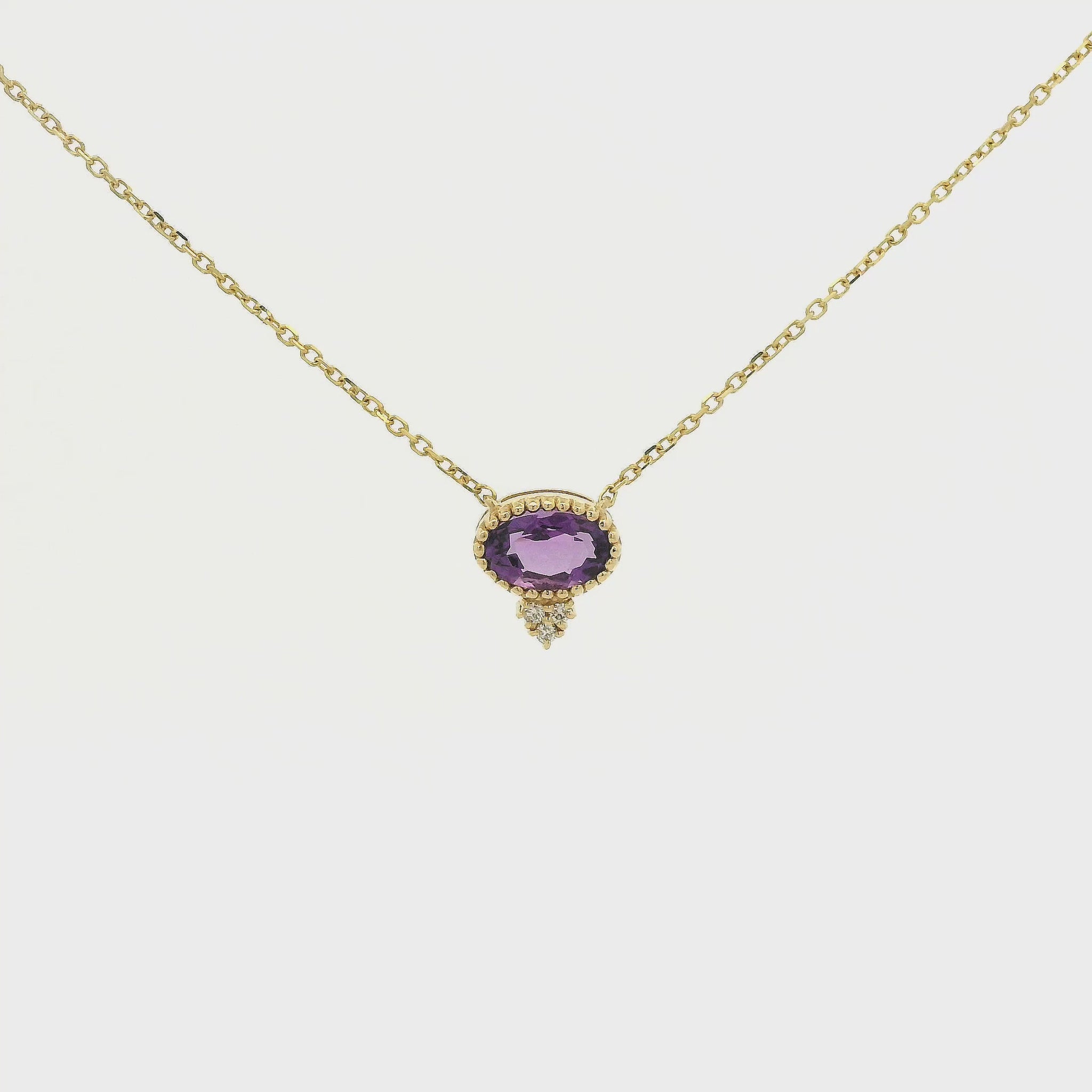 A Yellow Gold Pendant with a milgrain bezel set oval cut natural Amethyst in the center with 3 diamonds and a chain attached at Forever Rox Fine Jewelry, Lake Tahoes Best Jewelry Store