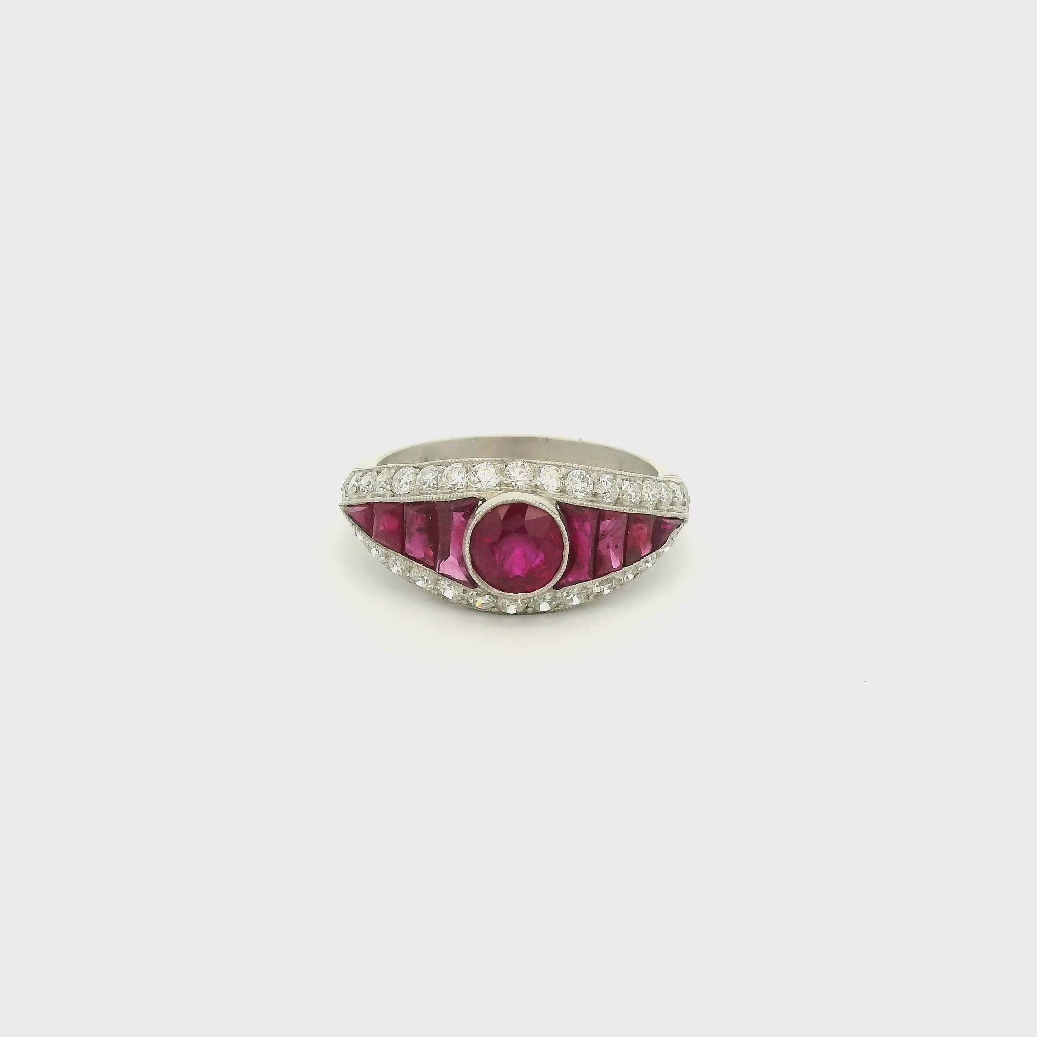 A Platinum Ring with a bezel set round cut natural Ruby in the center with baguette cut rubies and diamonds at Forever Rox Fine Jewelry, Lake Tahoes Best Jewelry Store