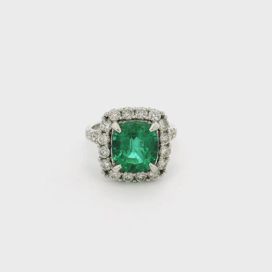 A White Gold Ring with a prong set cushion cut natural Emerald in the center with a diamond halo & diamonds down the shank at Forever Rox Fine Jewelry, Lake Tahoes Best Jewelry Store