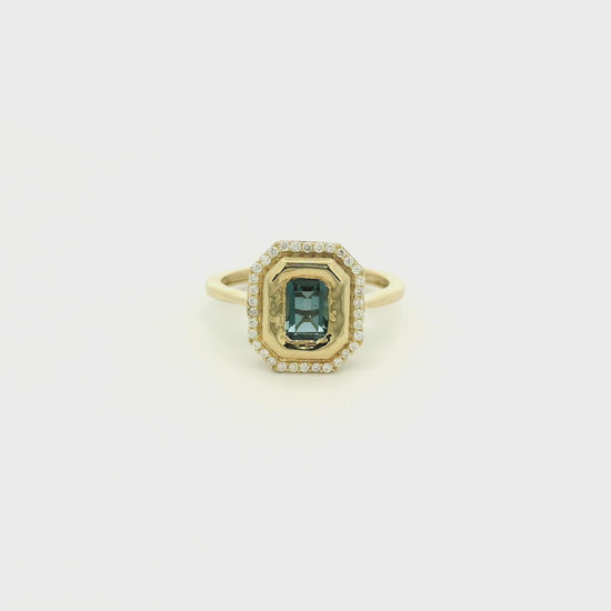 A Yellow Gold Ring with a bezel set emerald cut natural London Blue Topaz in the center with diamonds around the outside at Forever Rox Fine Jewelry, Lake Tahoes Best Jewelry Store
