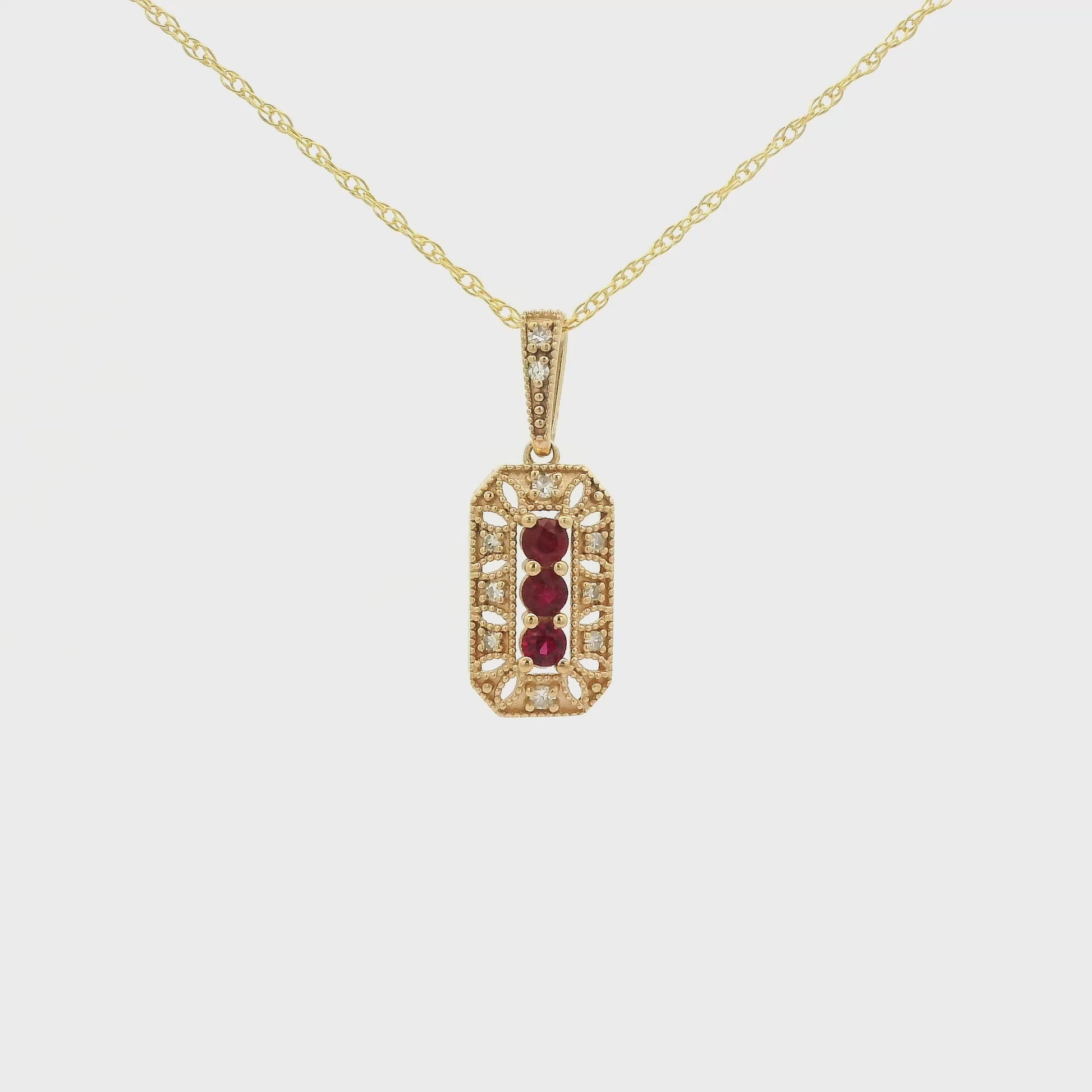 Yellow Gold Pendant with 3 prong set round cut natural Rubies in the center filigree design and diamonds at Forever Rox Fine Jewelry, Lake Tahoes Best Jewelry Store
