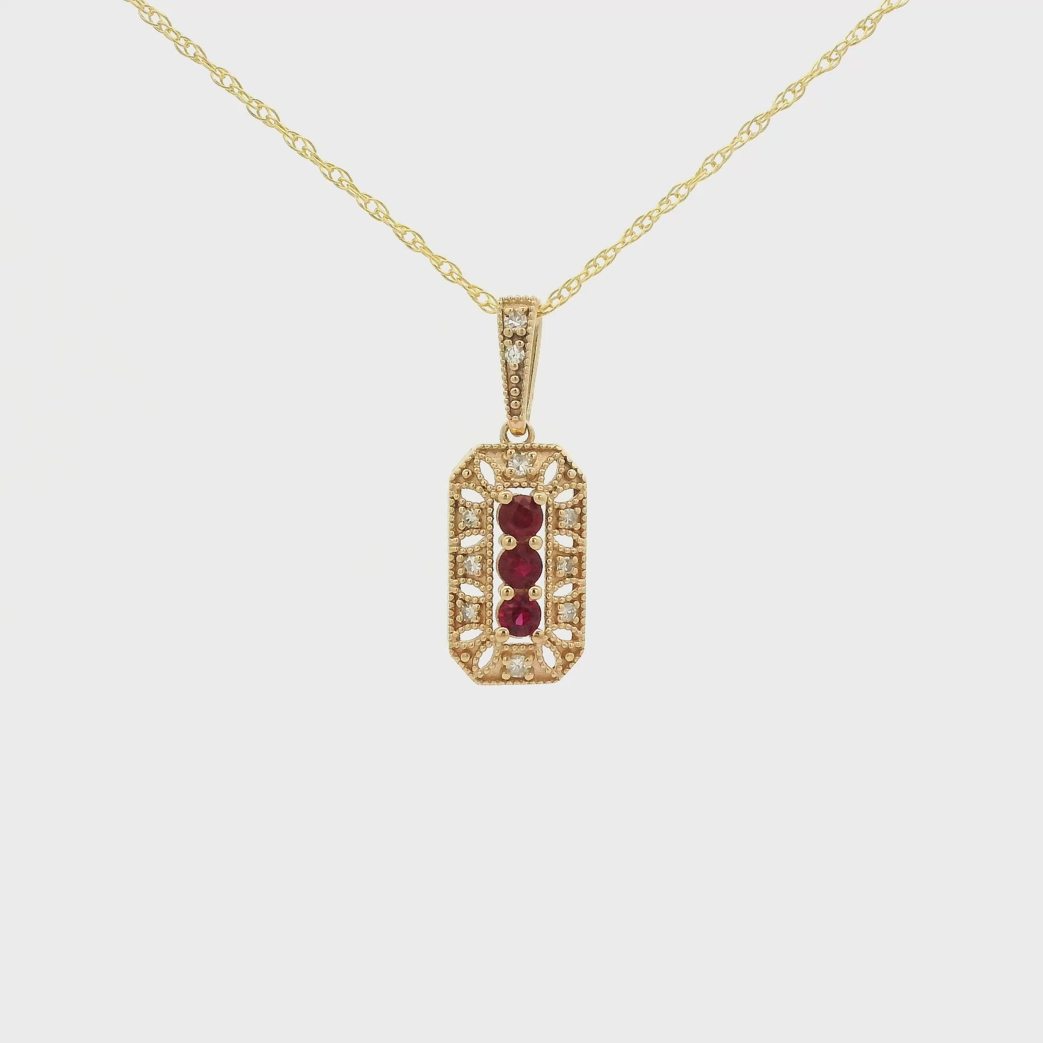 Yellow Gold Pendant with 3 prong set round cut natural Rubies in the center filigree design and diamonds at Forever Rox Fine Jewelry, Lake Tahoes Best Jewelry Store
