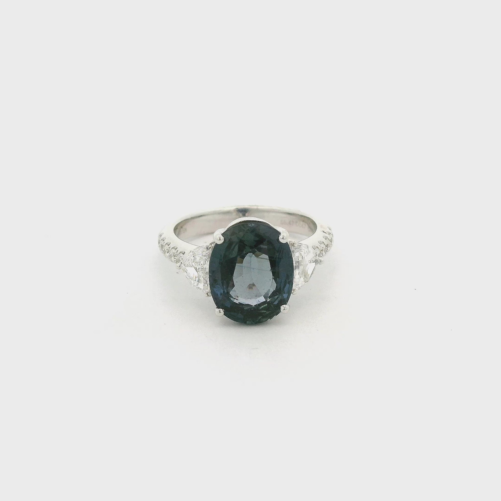A White Gold Ring with a prong set oval cut natural Color Change Sapphire in the center with two chevron cut natural diamonds and round cut diamonds Forever Rox Fine Jewelry, Lake Tahoes Best Jewelry Store