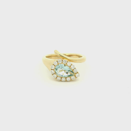 A Yellow Gold Ring with a bezel set pear cut natural Aquamarine in the center with a halo fo diamonds at Forever Rox Fine Jewelry, Lake Tahoes Best Jewelry Store