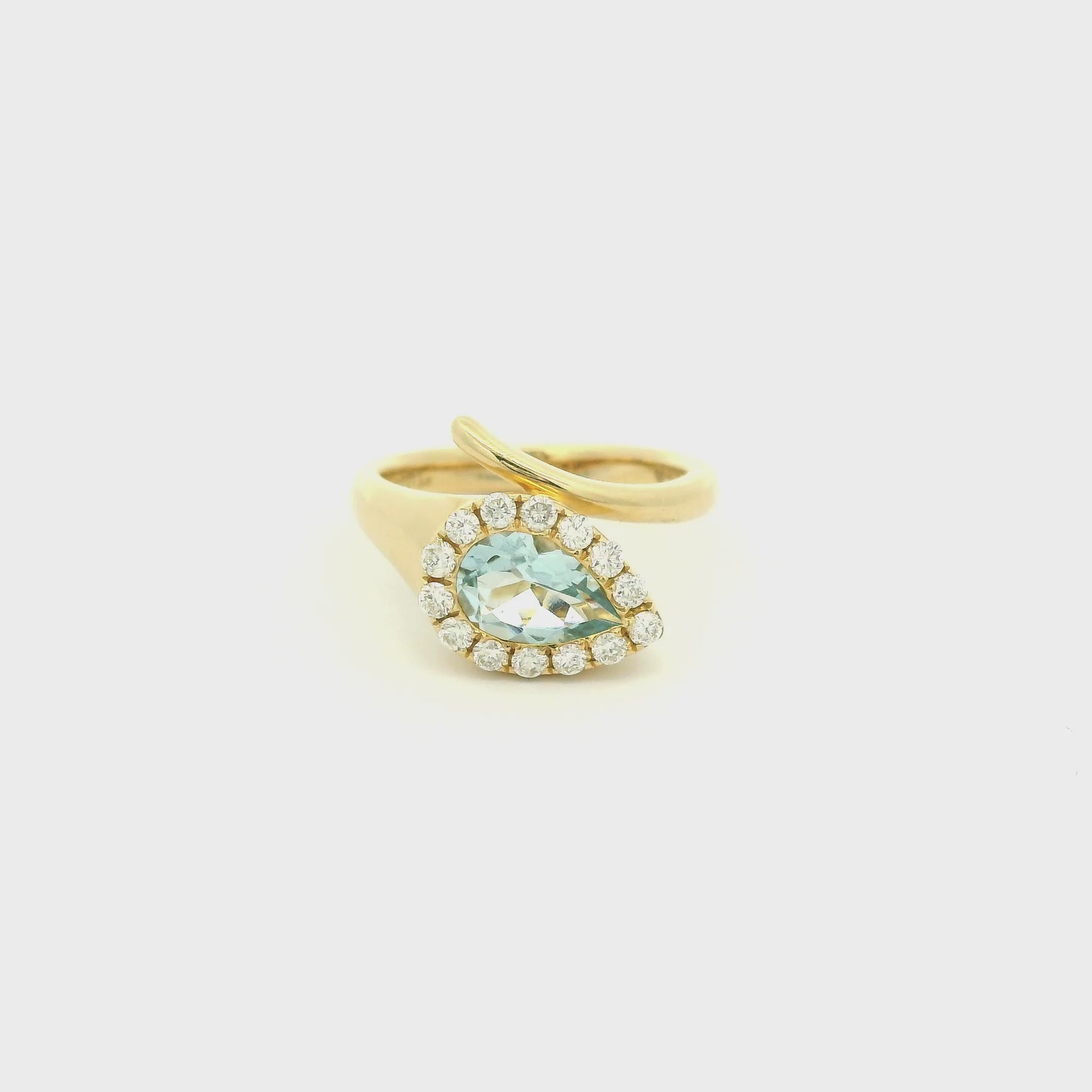 A Yellow Gold Ring with a bezel set pear cut natural Aquamarine in the center with a halo fo diamonds at Forever Rox Fine Jewelry, Lake Tahoes Best Jewelry Store