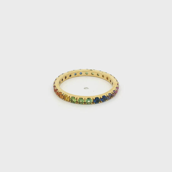 A Yellow Gold Eternity Band with natural Sapphires of all collors of the rainbow (red,orange,yellow,green,blue,purple,pink) all the way around at Forever Rox Fine Jewelry, Lake Tahoes Best Jewelry Store