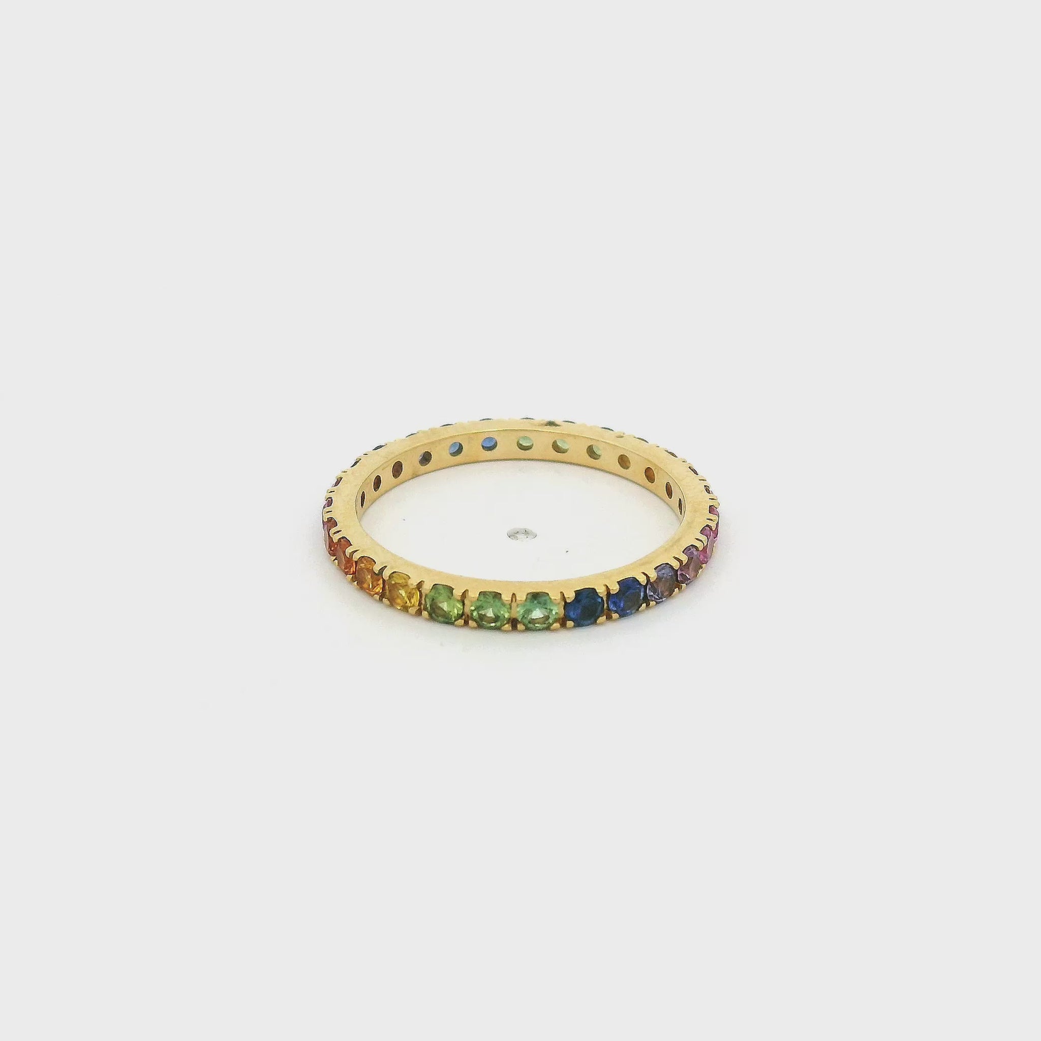A Yellow Gold Eternity Band with natural Sapphires of all collors of the rainbow (red,orange,yellow,green,blue,purple,pink) all the way around at Forever Rox Fine Jewelry, Lake Tahoes Best Jewelry Store