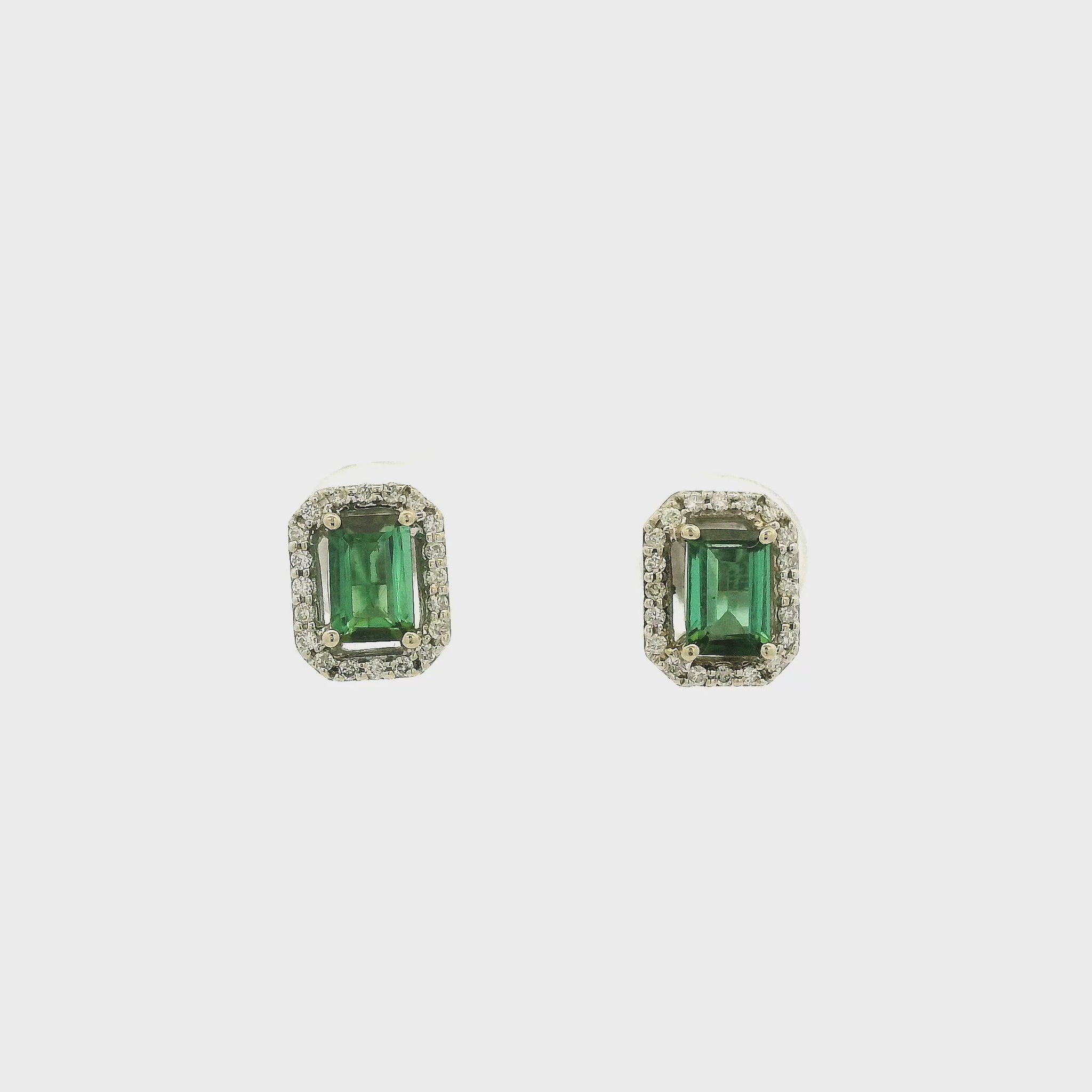 A Pair of White Gold Earrings with prong set emerald cut natural Green Tourmaline in the center with a diamond halo at Forever Rox Fine Jewelry, Lake Tahoes Best Jewelry Store