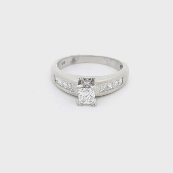 White Gold ring with a princess cut diaond in the center and four princess cut diamonds channel set down each shank at Forever Rox Fine Jewelry 