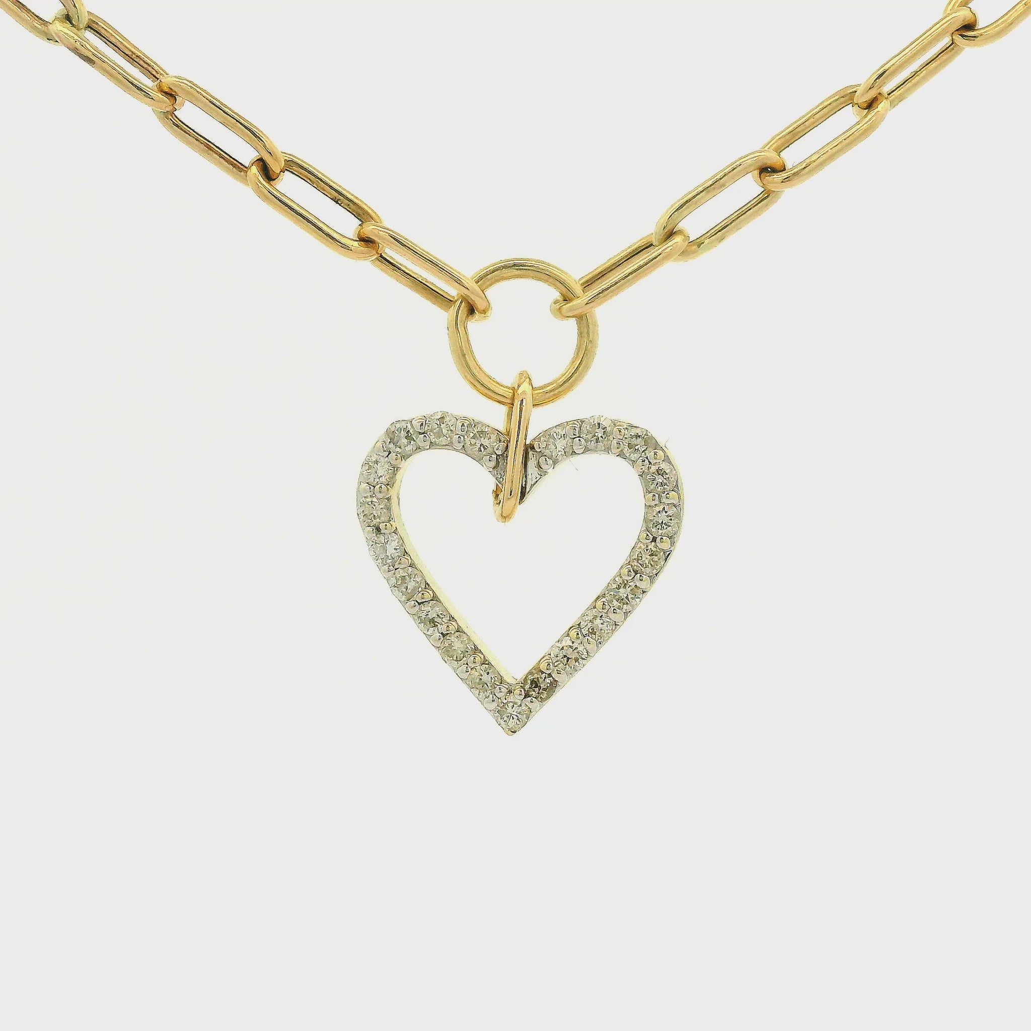 A gold heart-shaped pendant necklace with a pavé diamond outline, suspended from a gold paperclip chain on a white background at Forever Rox Fine Jewelry, Lake Tahoes Best Jewelry Store