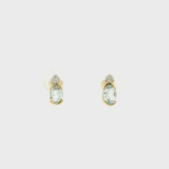 A Pair of Yellow Gold Stud Earrings with half bezel set oval cut natural Aquamarines and round cut diamonds at Forever Rox Fine Jewelry, Lake Tahoes Best Jewelry Store
