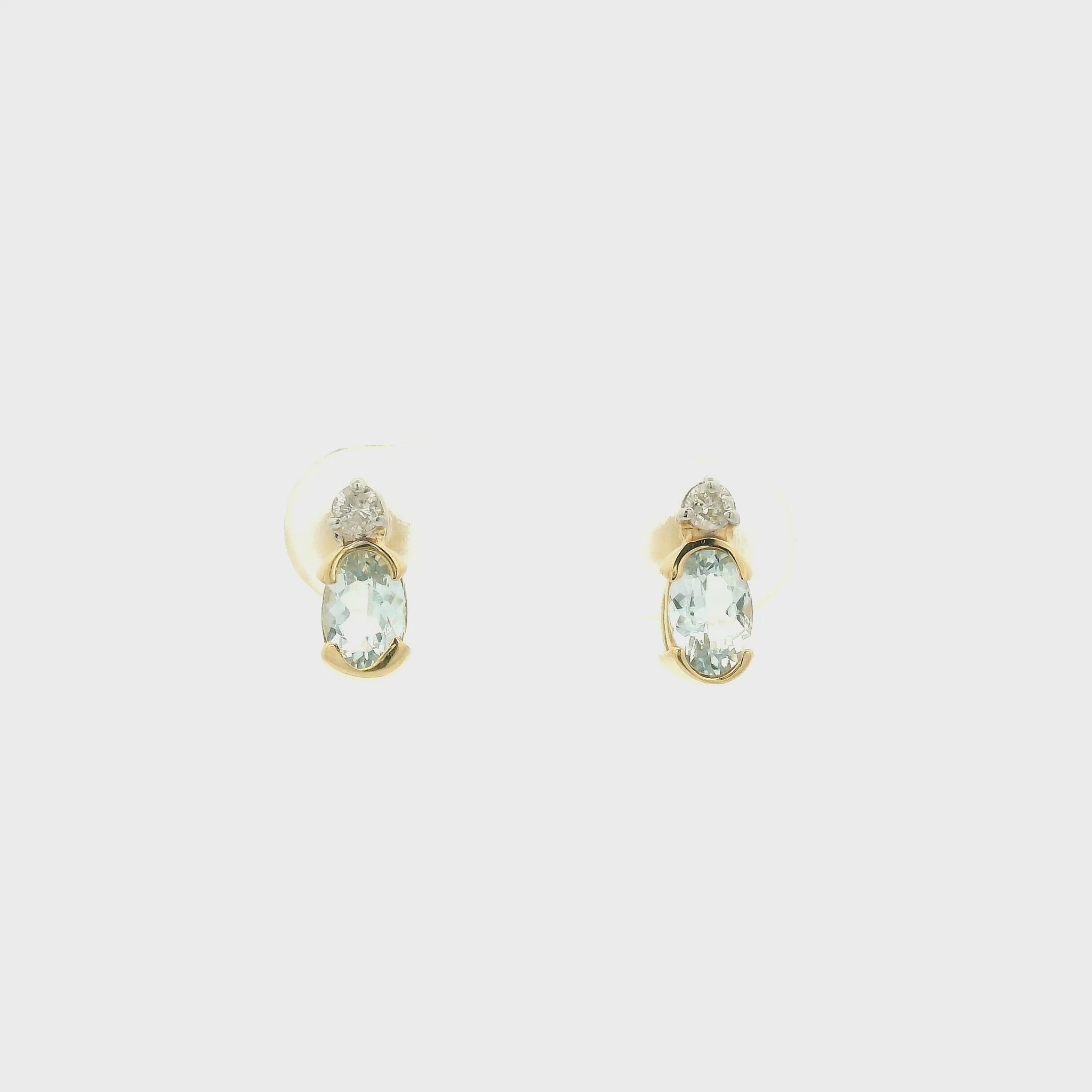 A Pair of Yellow Gold Stud Earrings with half bezel set oval cut natural Aquamarines and round cut diamonds at Forever Rox Fine Jewelry, Lake Tahoes Best Jewelry Store
