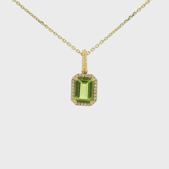A Yellow Gold Pendant with a prong set emerald cut natural Peridot in the center with a diamond halo at Forever Rox Fine Jewelry, Lake Tahoes Best Jewelry Store
