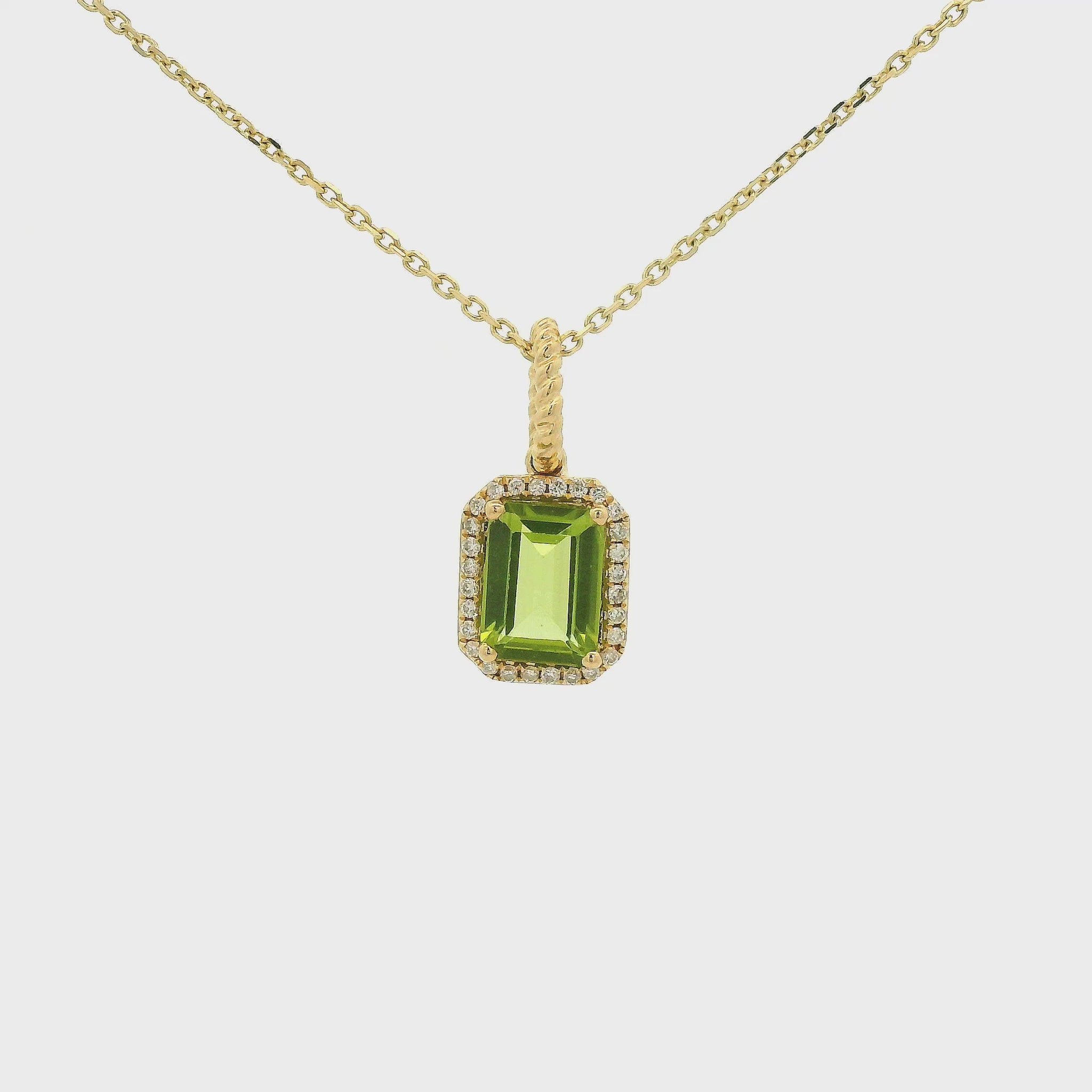 A Yellow Gold Pendant with a prong set emerald cut natural Peridot in the center with a diamond halo at Forever Rox Fine Jewelry, Lake Tahoes Best Jewelry Store
