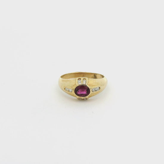 A Yellow Gold Ring with a bezel set oval cut natural Ruby in the center with eight diamonds bezel set at Forever Rox Fine Jewelry, Lake Tahoes Best Jewelry Store
