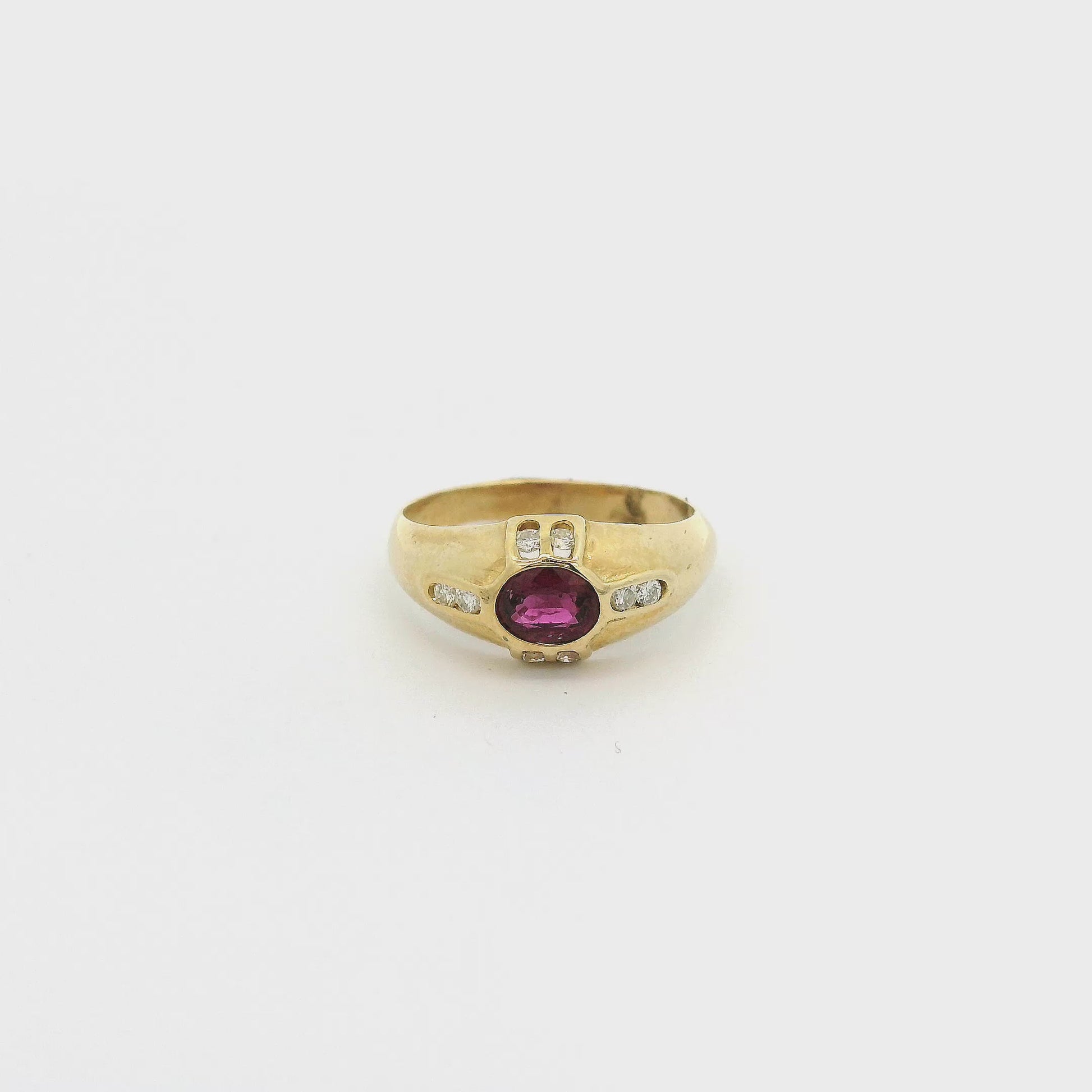 A Yellow Gold Ring with a bezel set oval cut natural Ruby in the center with eight diamonds bezel set at Forever Rox Fine Jewelry, Lake Tahoes Best Jewelry Store

