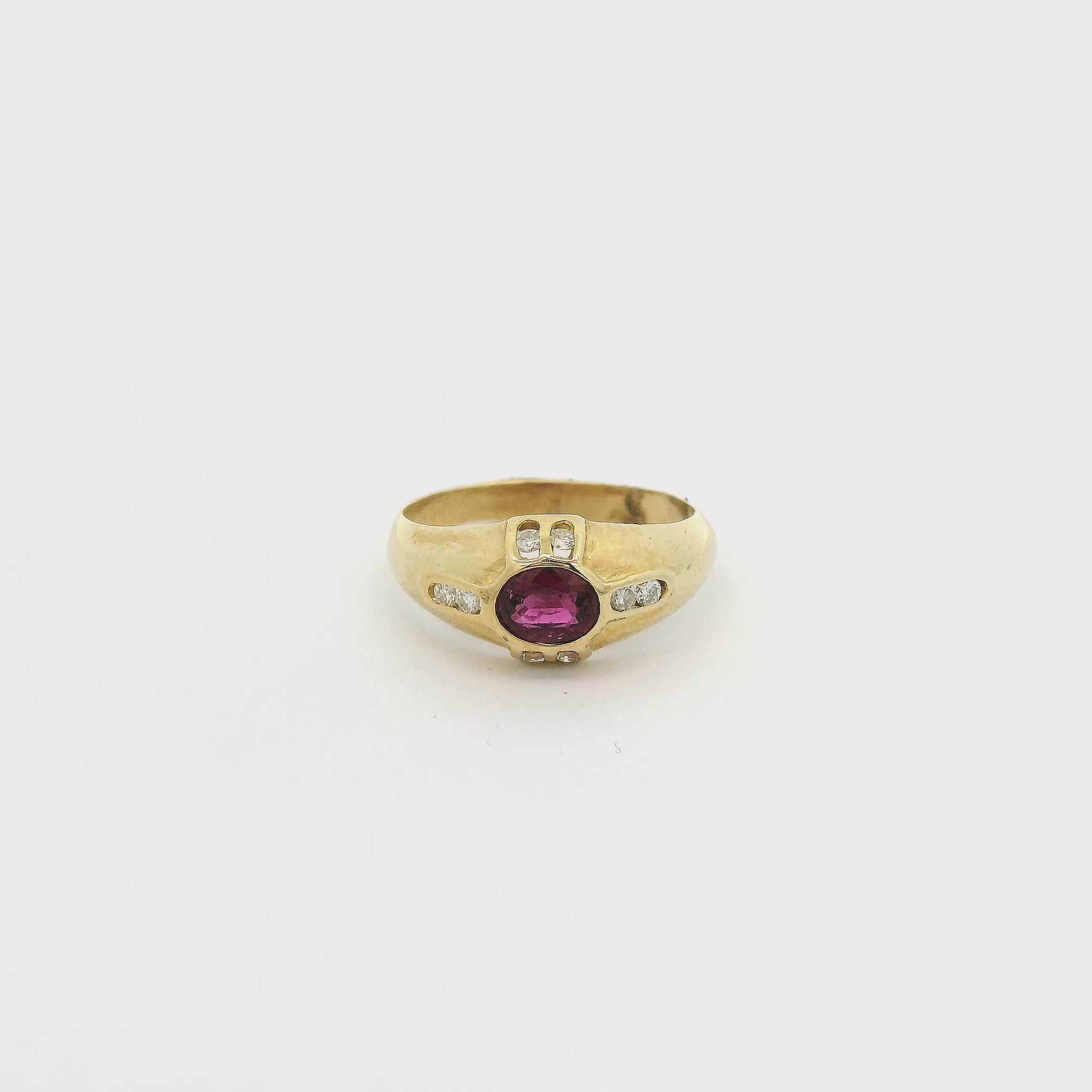 A Yellow Gold Ring with a bezel set oval cut natural Ruby in the center with eight diamonds bezel set at Forever Rox Fine Jewelry, Lake Tahoes Best Jewelry Store
