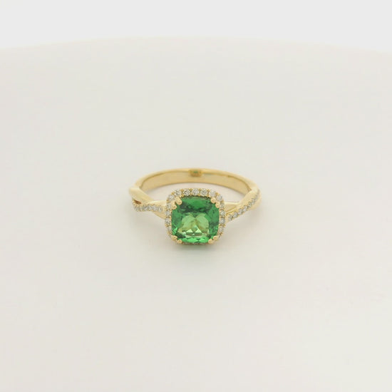 A Yellow Gold Crossover Ring with a prong set cushion cut natural Tsavorite in the center with a halo of diamonds and diamonds down shank at Forever Rox Fine Jewelry, Lake Tahoes Best Jewelry Store