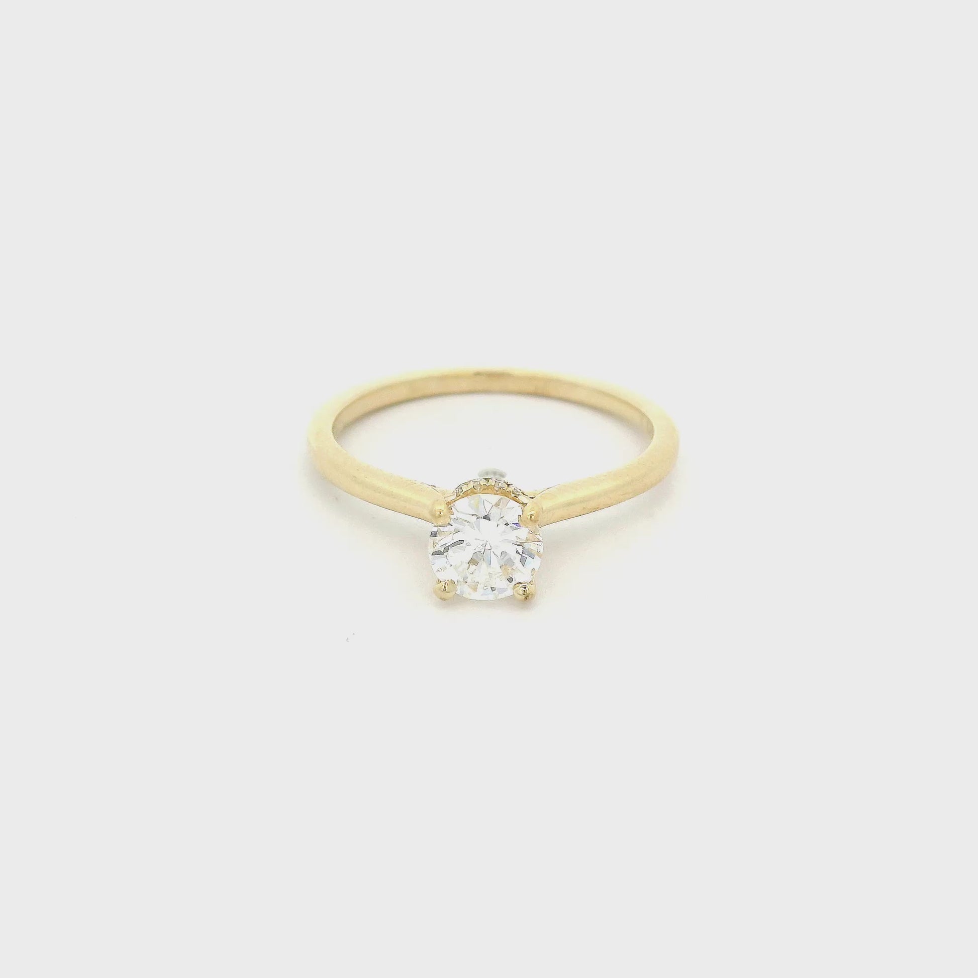 Yellow Gold ring with a solitaire set round cut diamond and diamonds around the bottom of the head at Forever Rox Fine Jewelry