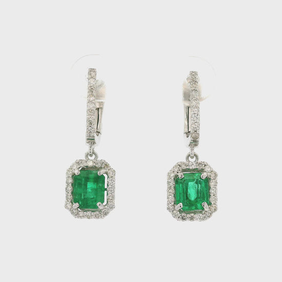 A Pair of Emerald Cut Emeralds Set in White Gold Diamond Dangle Earrings at Forever Rox Fine Jewelry