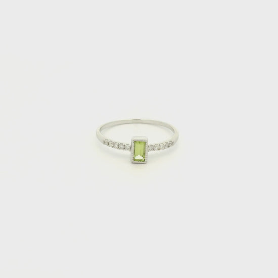 A White Gold Ring with a milgrain bezel set baguette cut natural Peridot in the center with diamonds down the shank at Forever Rox Fine Jewelry, Lake Tahoes Best Jewelry Store