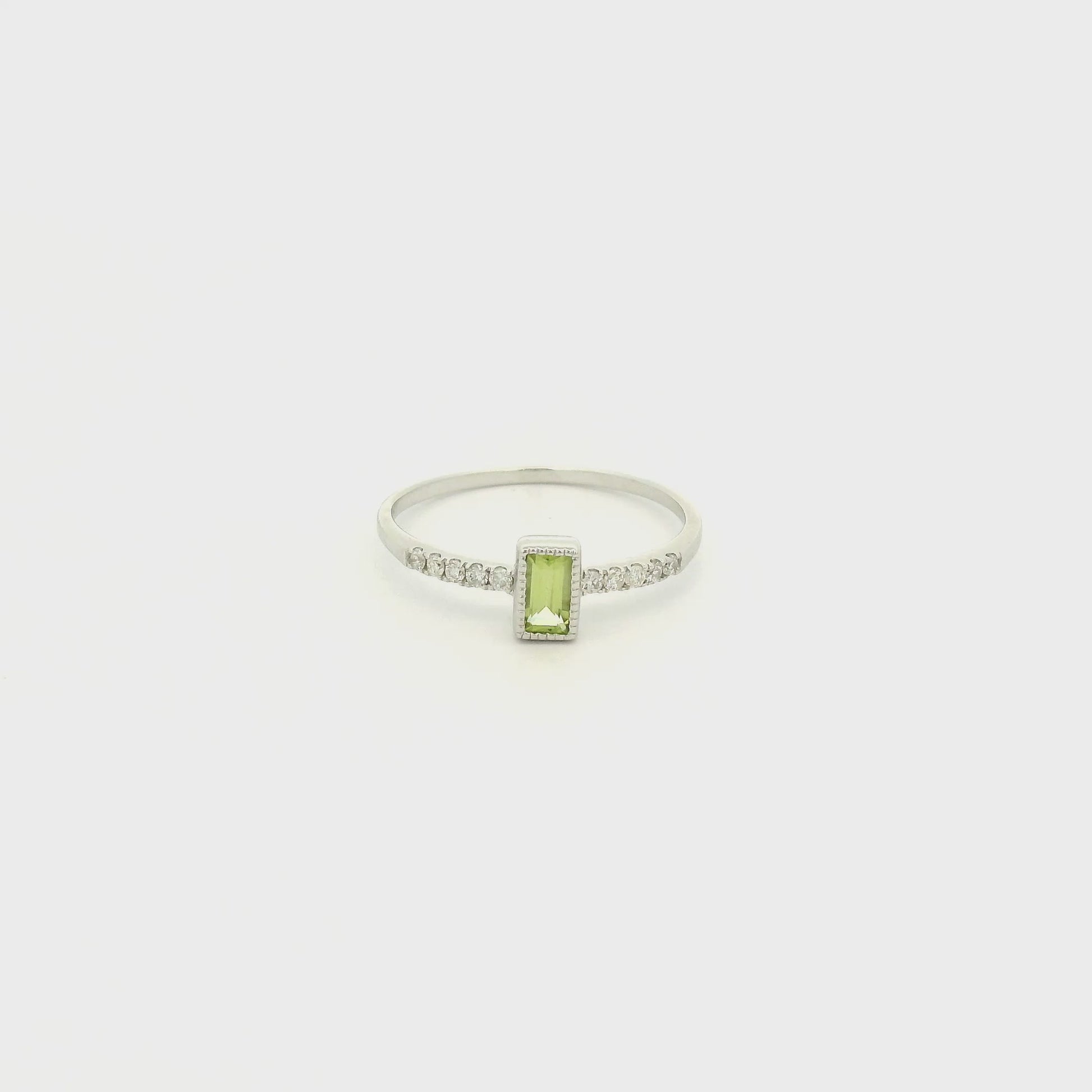 A White Gold Ring with a milgrain bezel set baguette cut natural Peridot in the center with diamonds down the shank at Forever Rox Fine Jewelry, Lake Tahoes Best Jewelry Store