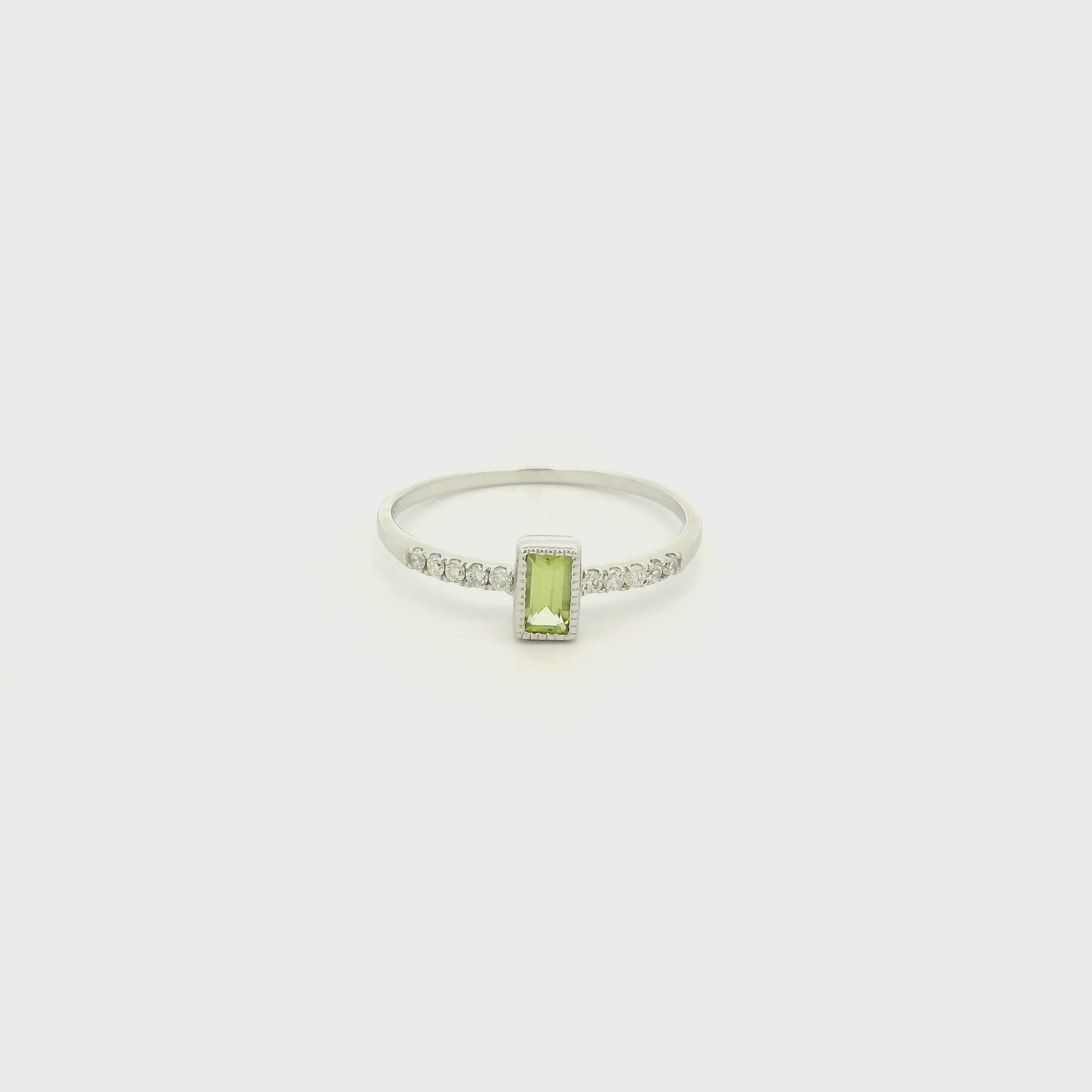 A White Gold Ring with a milgrain bezel set baguette cut natural Peridot in the center with diamonds down the shank at Forever Rox Fine Jewelry, Lake Tahoes Best Jewelry Store