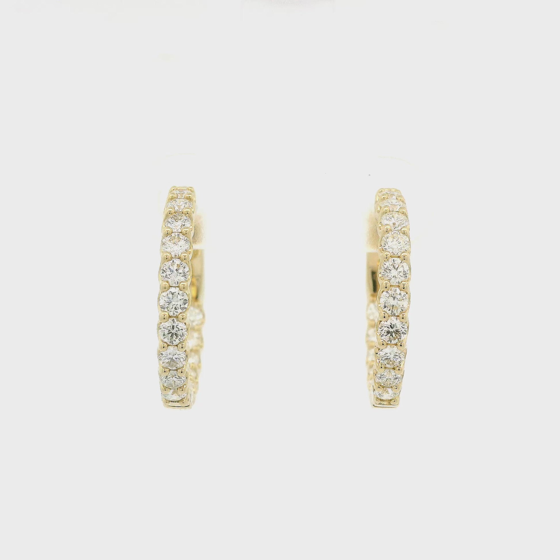 a Pair Of Yellow Gold Hoops With Diamonds Inside and Outside at Forever Rox Fine Jewelry