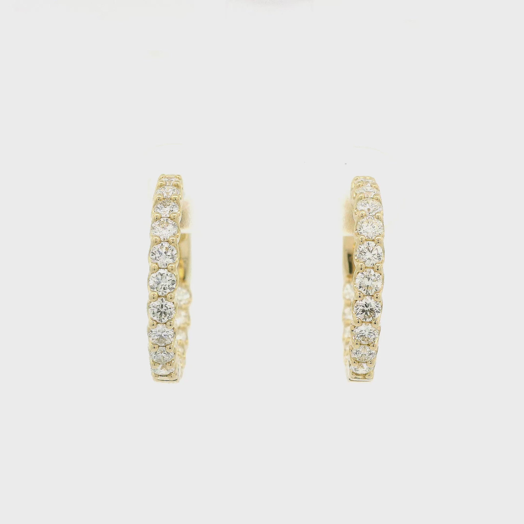 a Pair Of Yellow Gold Hoops With Diamonds Inside and Outside at Forever Rox Fine Jewelry