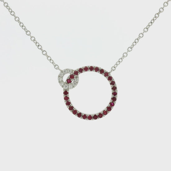 A White Gold Pendant with two circles and prong set round cut natural Rubies in the bigger circle and round cut diamonds in the smaller circle with a chain attached at Forever Rox Fine Jewelry, Lake Tahoes Best Jewelry Store