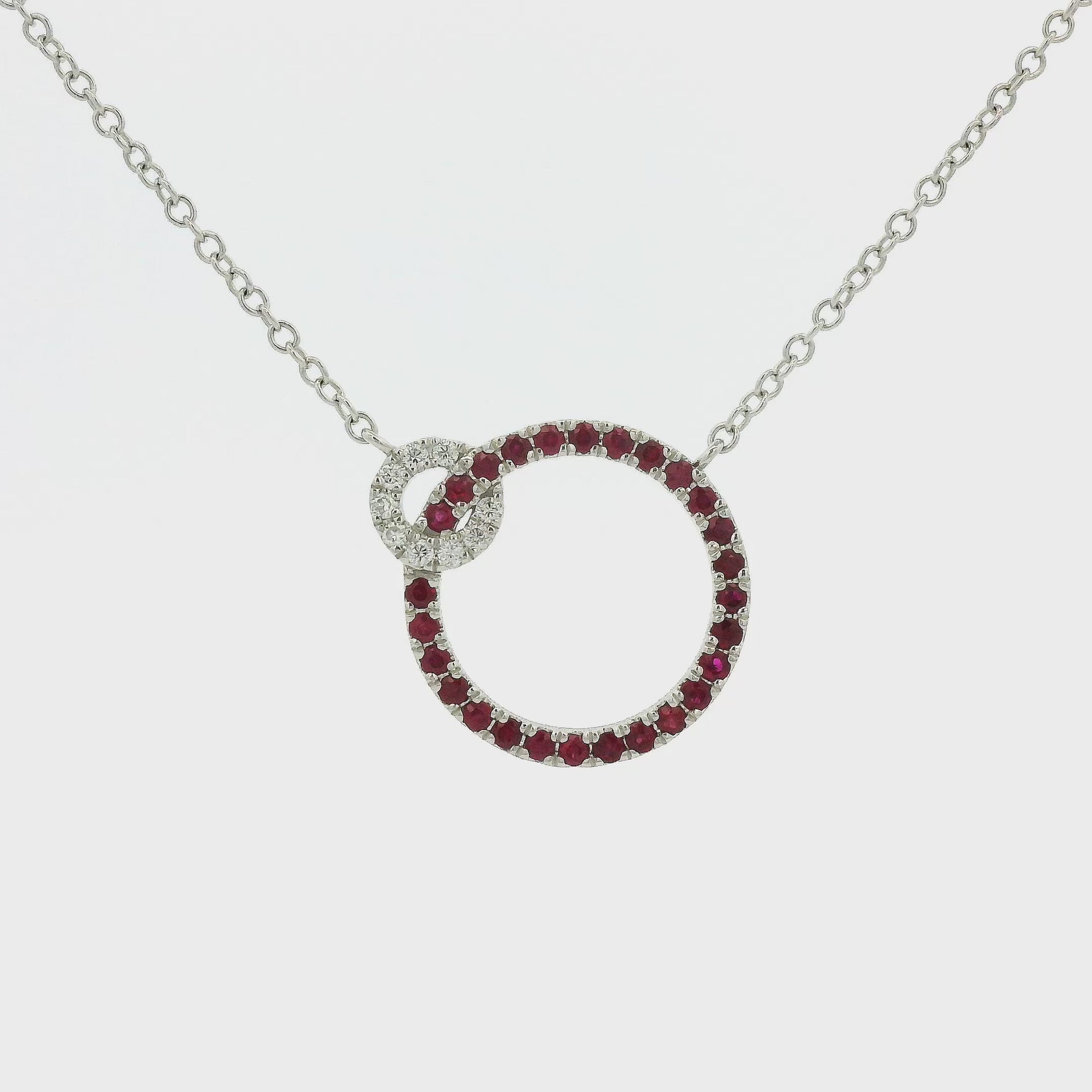 A White Gold Pendant with two circles and prong set round cut natural Rubies in the bigger circle and round cut diamonds in the smaller circle with a chain attached at Forever Rox Fine Jewelry, Lake Tahoes Best Jewelry Store