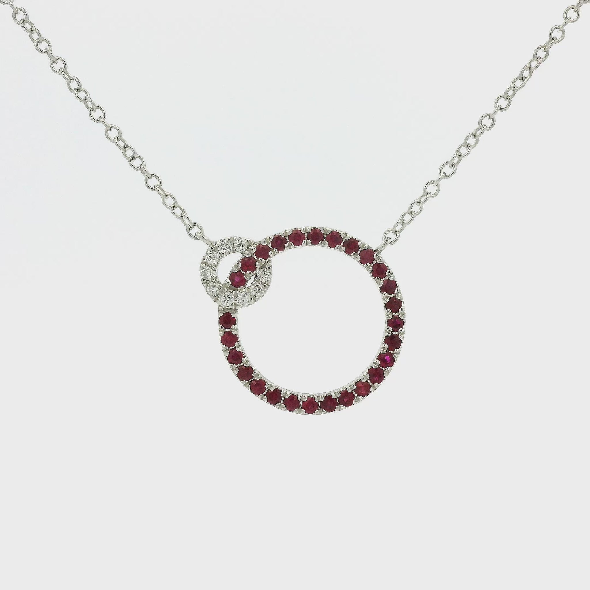 A White Gold Pendant with two circles and prong set round cut natural Rubies in the bigger circle and round cut diamonds in the smaller circle with a chain attached at Forever Rox Fine Jewelry, Lake Tahoes Best Jewelry Store