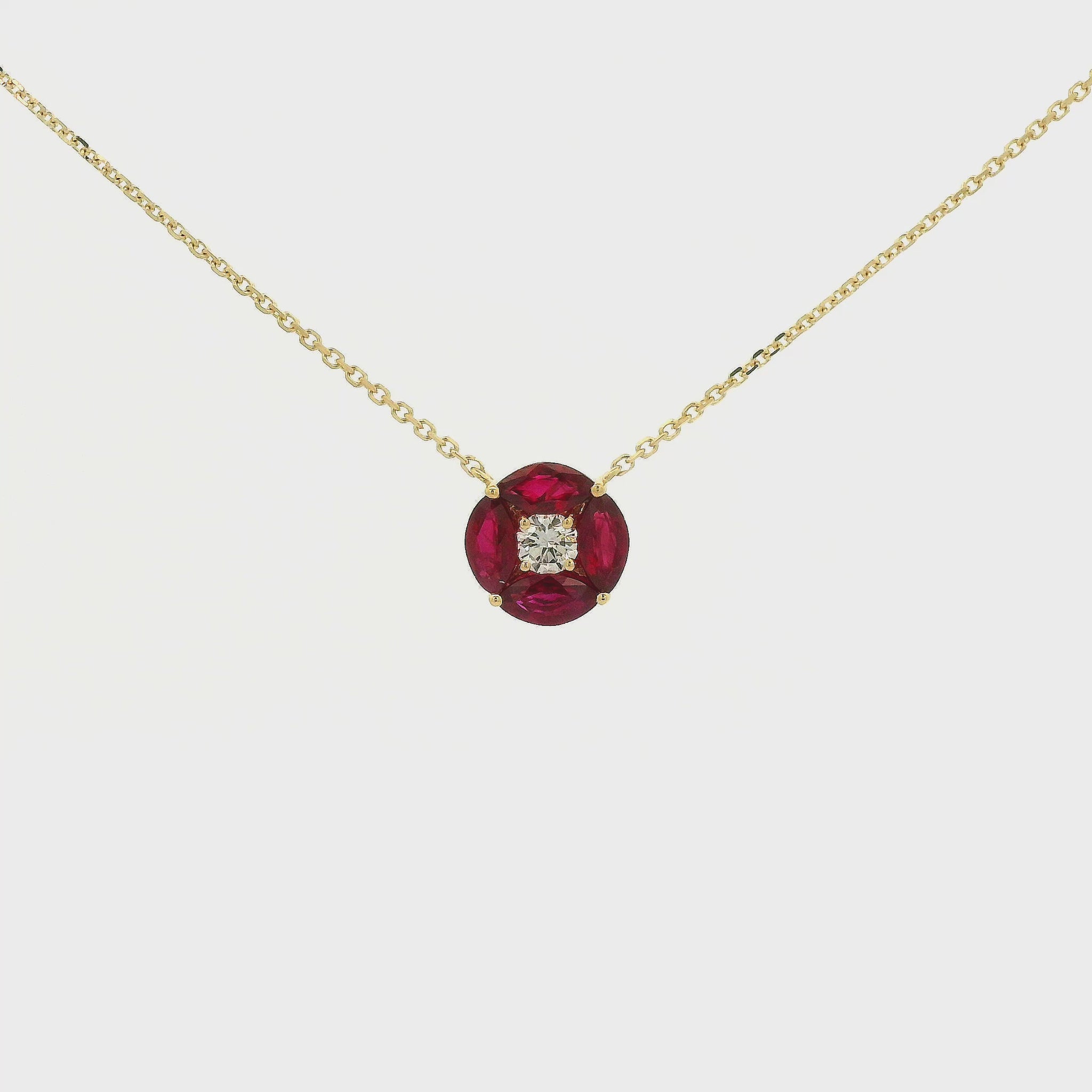 A Yellow Gold Pendant with a round cut diamond in the center & 4 marquise cut rubies in a circle around it at Forever Rox Fine Jewelry, Lake Tahoes Best Jewelry Store