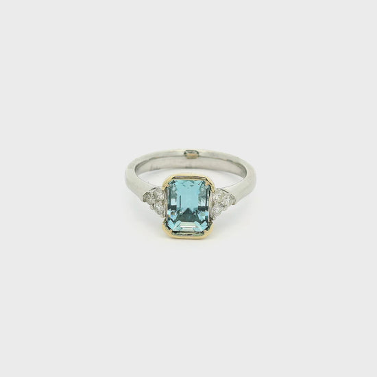 A White Gold Ring with a Yellow Gold bezel set emerald cut natural Aquamarine in the center with 3 diamonds on each side at Forever Rox Fine Jewelry, Lake Tahoes Best Jewelry Store