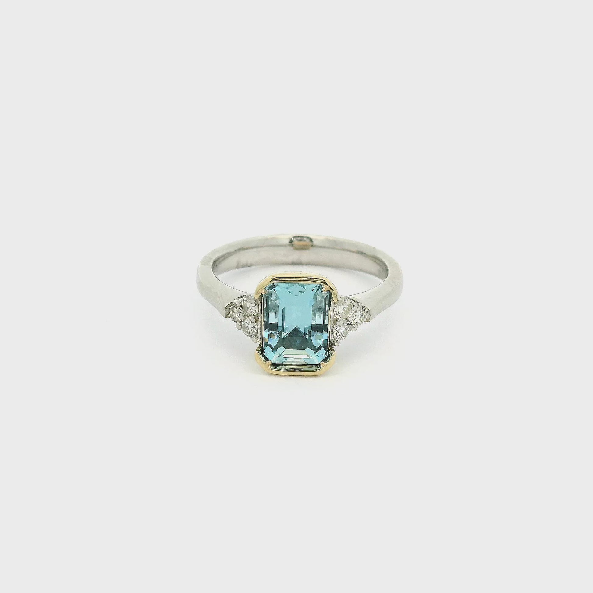 A White Gold Ring with a Yellow Gold bezel set emerald cut natural Aquamarine in the center with 3 diamonds on each side at Forever Rox Fine Jewelry, Lake Tahoes Best Jewelry Store