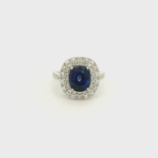 A Platinum Ring with a Prong set oval cut natural GIA certified Sapphire in the center with a halo of pavé diamonds at Forever Rox Fine Jewelry, Lake Tahoes Best Jewelry Store
